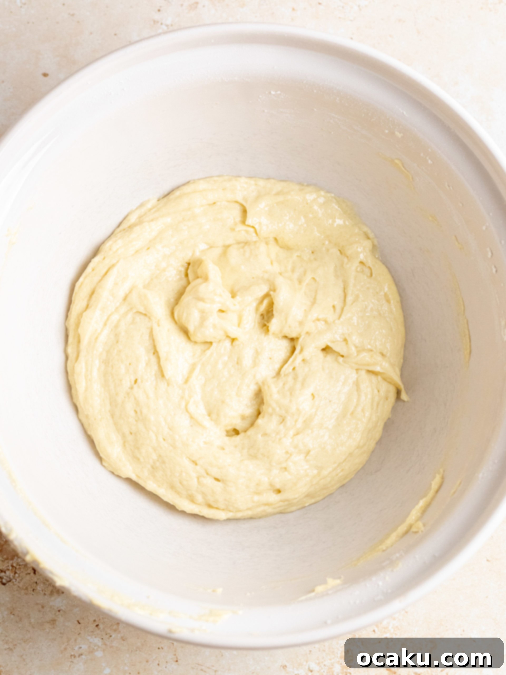 Two bowls, one with white batter, the other with red batter.