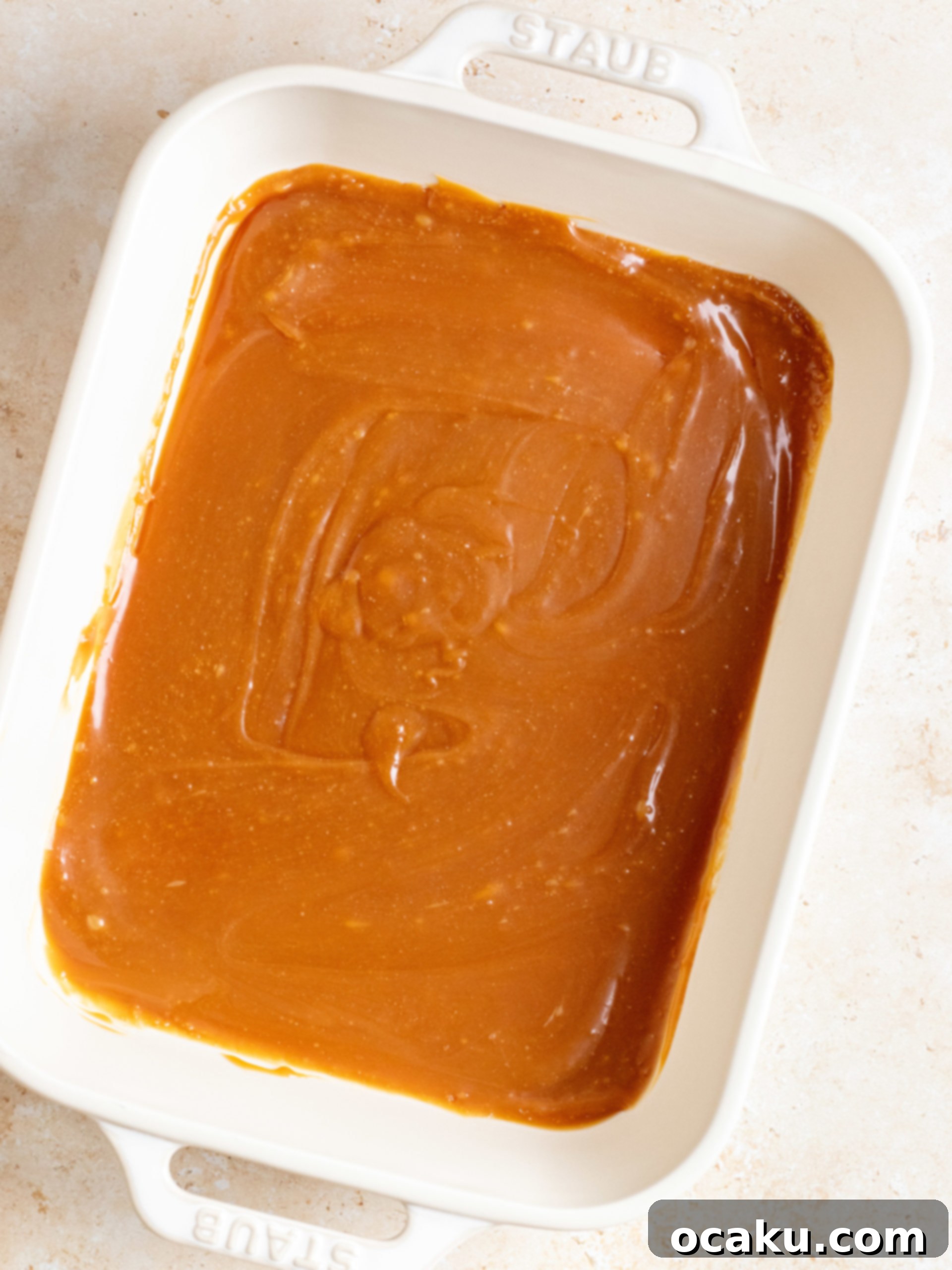 Granulated sugar and water heating in a pan to make caramel.