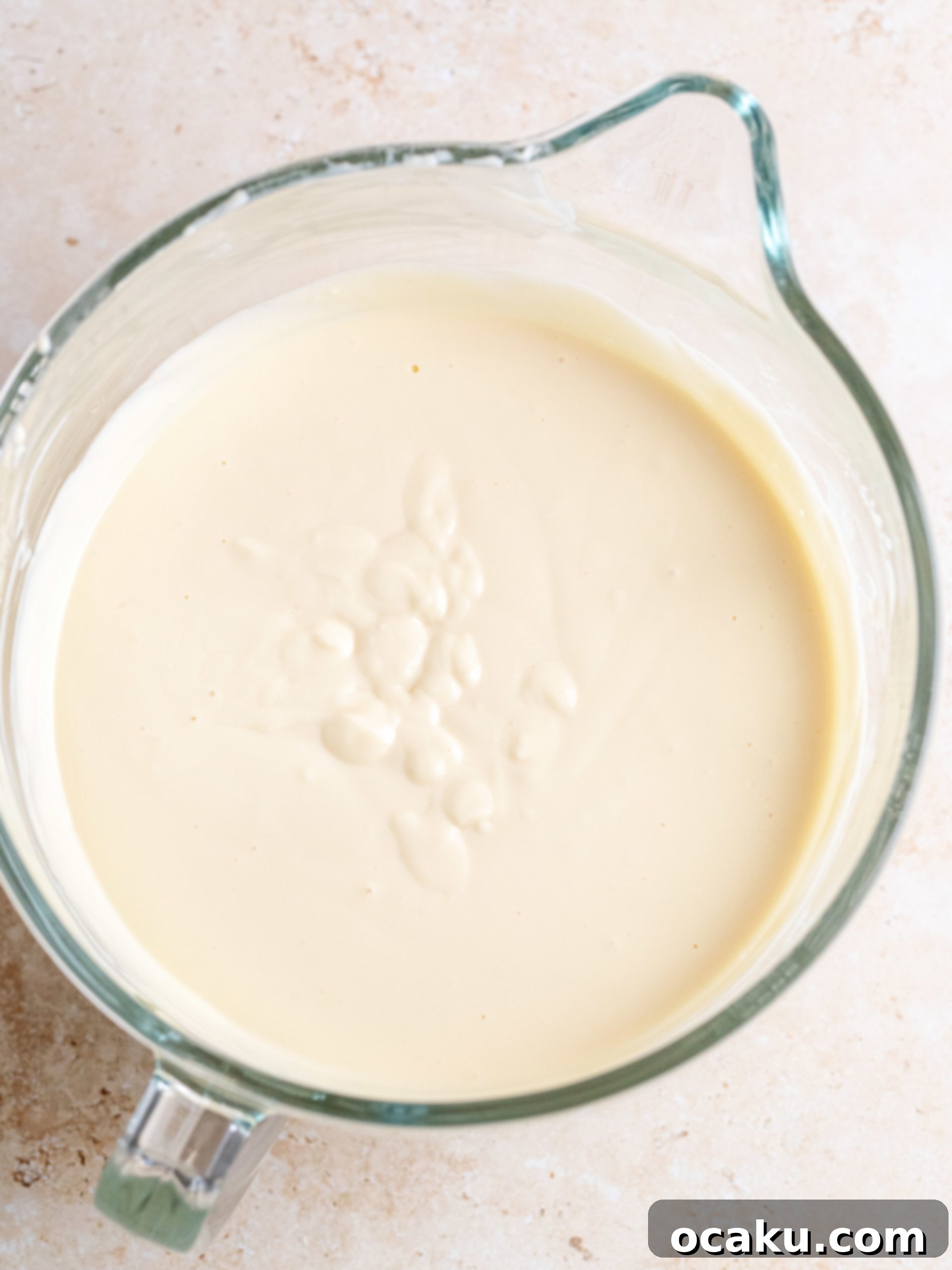 Golden brown caramel sauce in a pan after adding butter and cream.