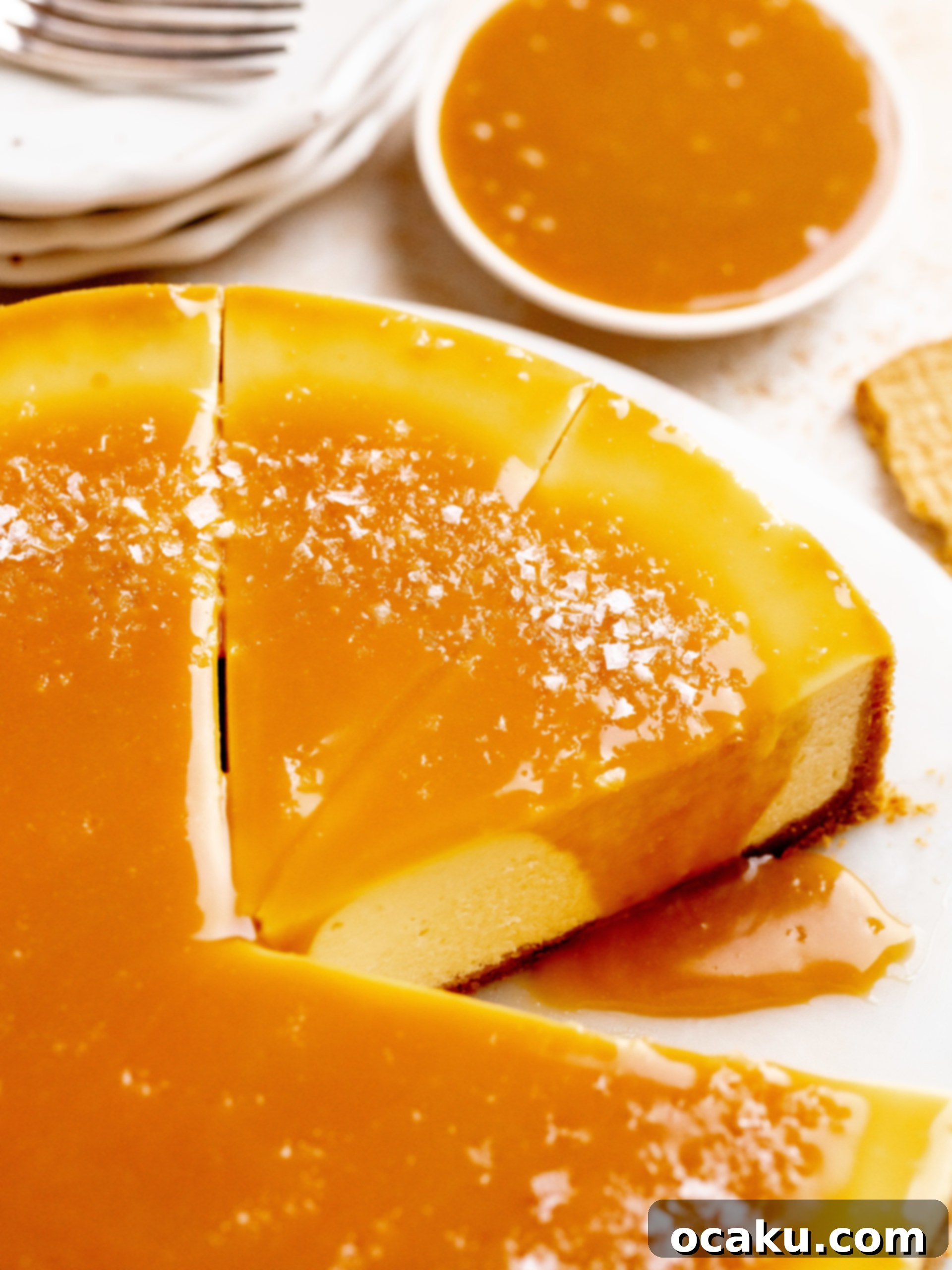 A slice of salted caramel cheesecake with a fork, ready to be eaten.