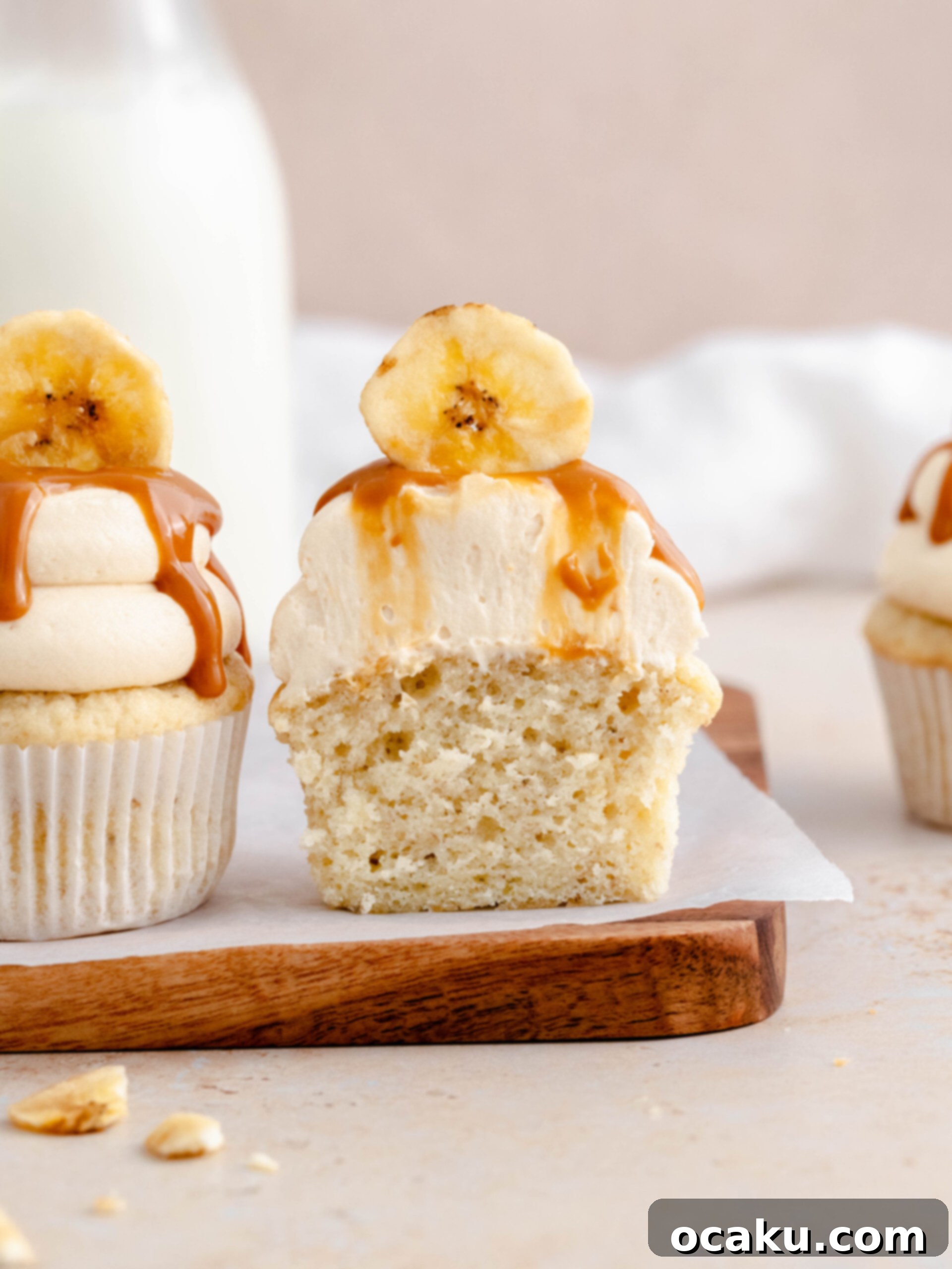 Aperol Spritz Cheesecake A banoffee cupcake cut in half, revealing the moist banana cake and creamy dulce de leche filling.