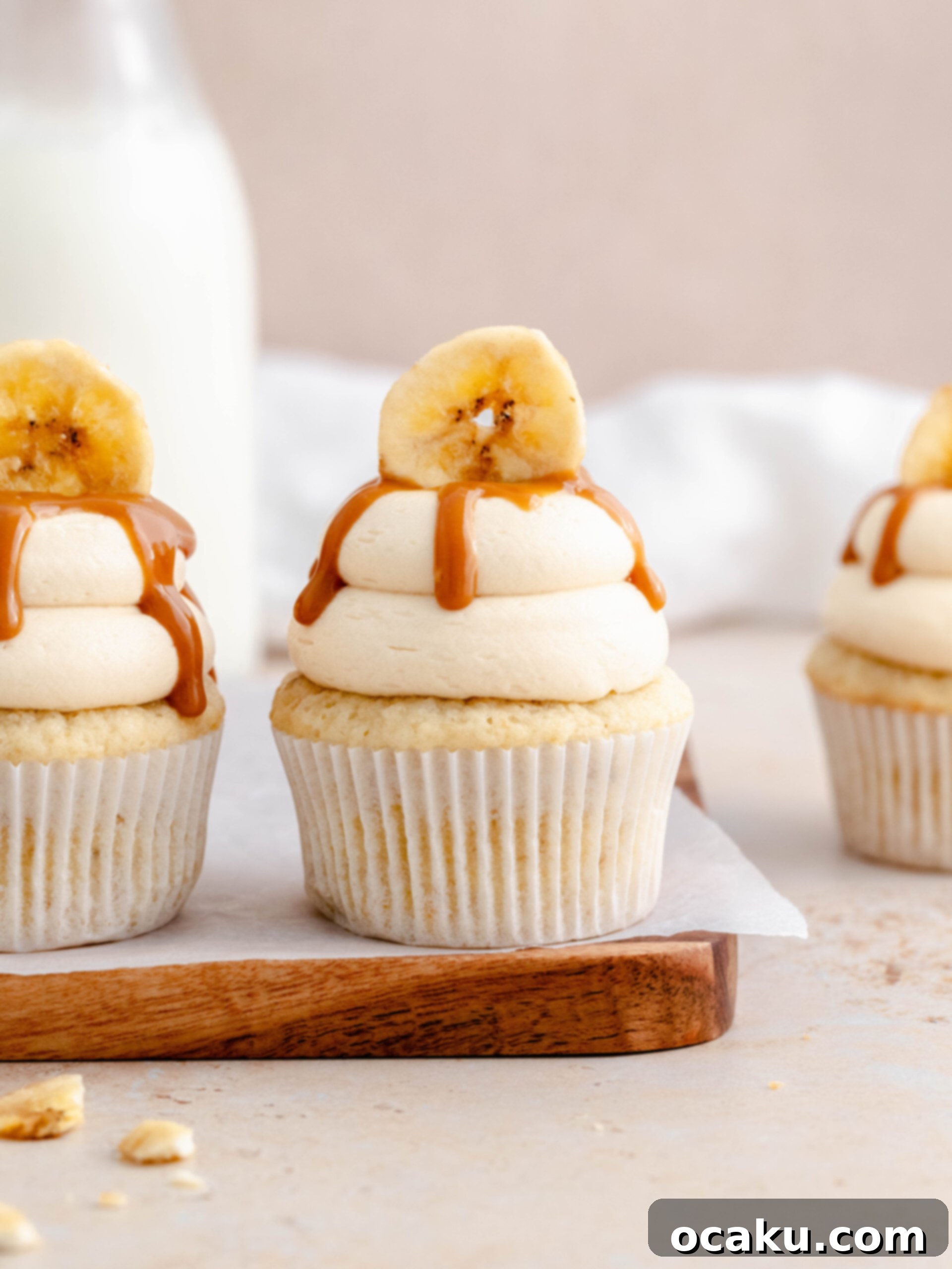 Dreamy Banoffee Cupcakes 4 Freshly baked banana cupcakes cooling on a wire rack, ready for frosting.
