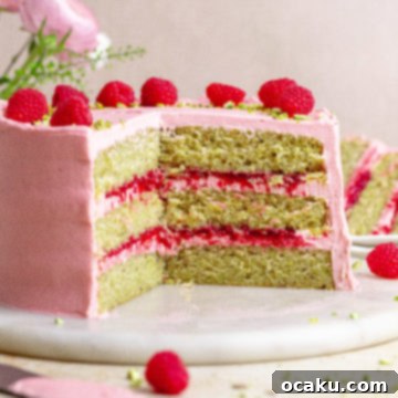 The finished Raspberry Pistachio Cake, ready to be served, showcasing its beautiful layers.