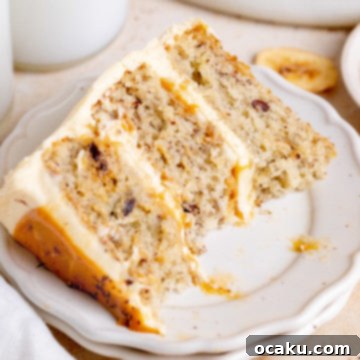 A cross-section of the Banoffee Layer Cake showcasing the moist banana cake, creamy dulce de leche, and fresh banana slices within the layers.