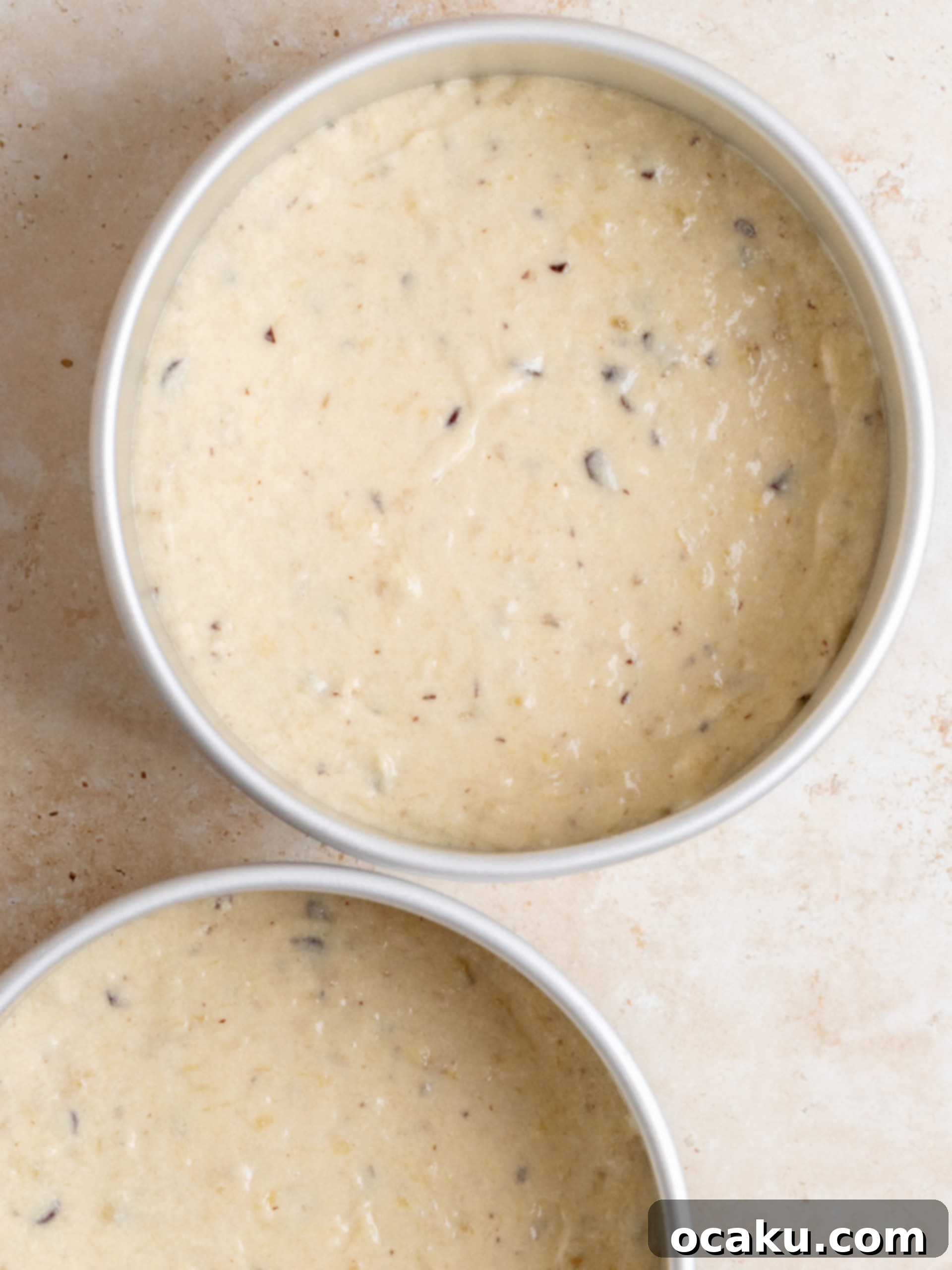 Three perfectly baked banana cake layers cooling on a wire rack, having just been removed from their baking pans.