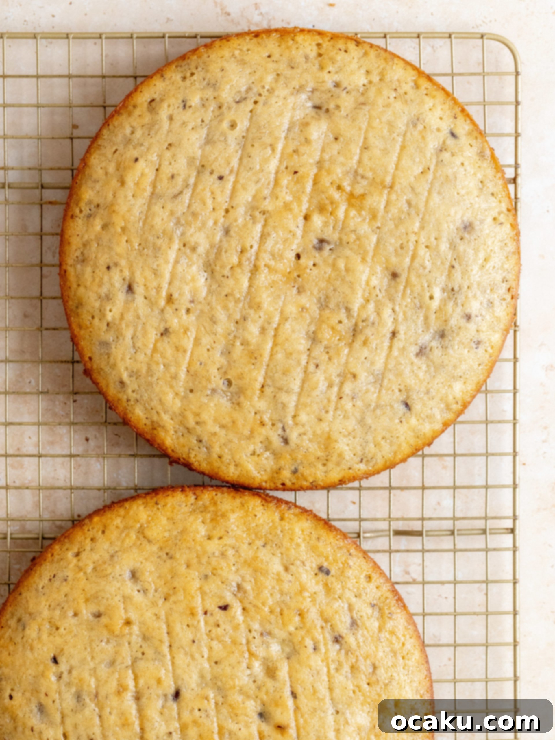 Another perspective of the Banoffee Layer Cake during assembly, showcasing the meticulous layering of cake, dulce de leche buttercream, and fresh bananas.