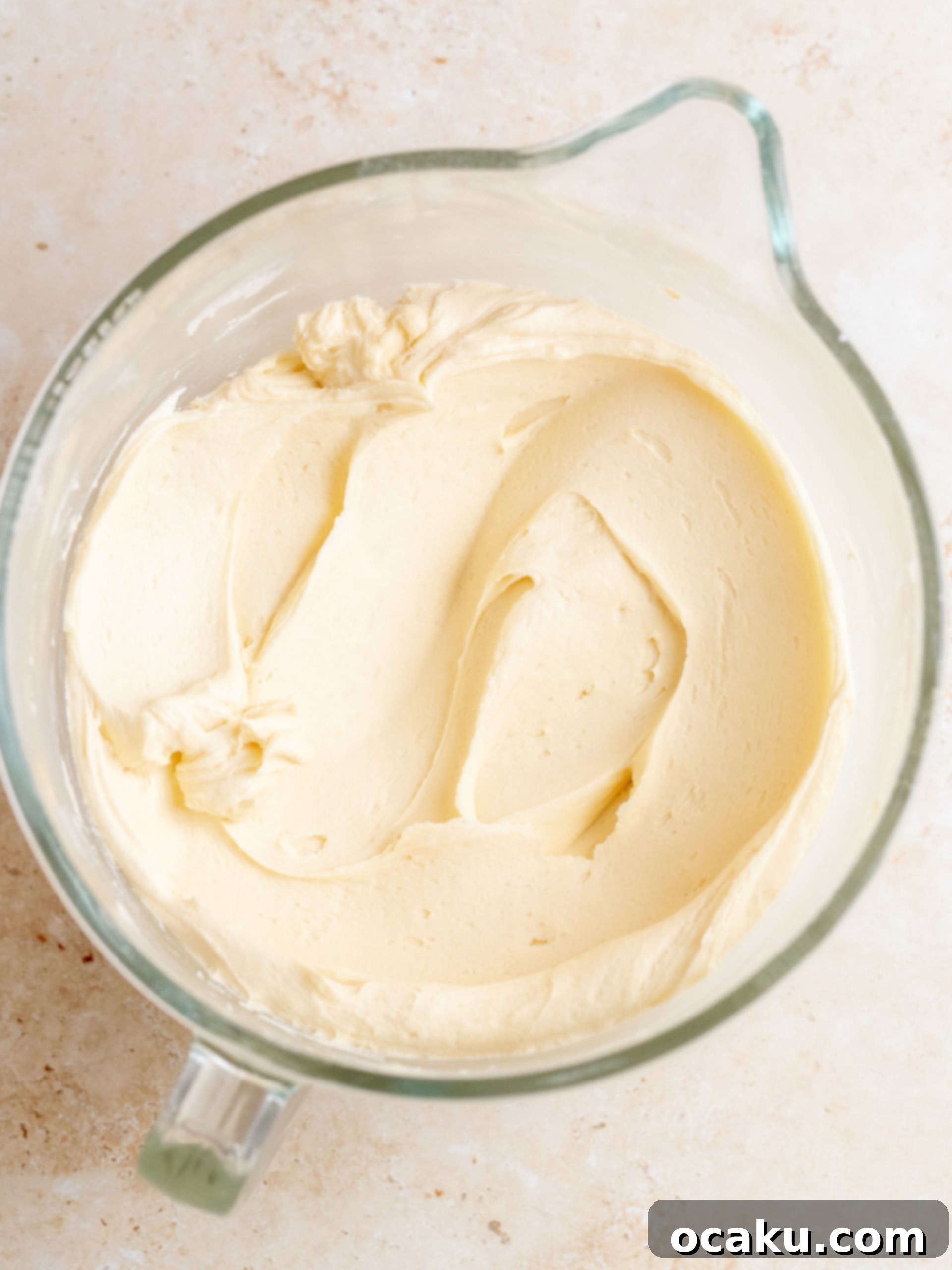A Banoffee Layer Cake after being covered in a smooth, even crumb coat, ready for its final layer of luscious buttercream.