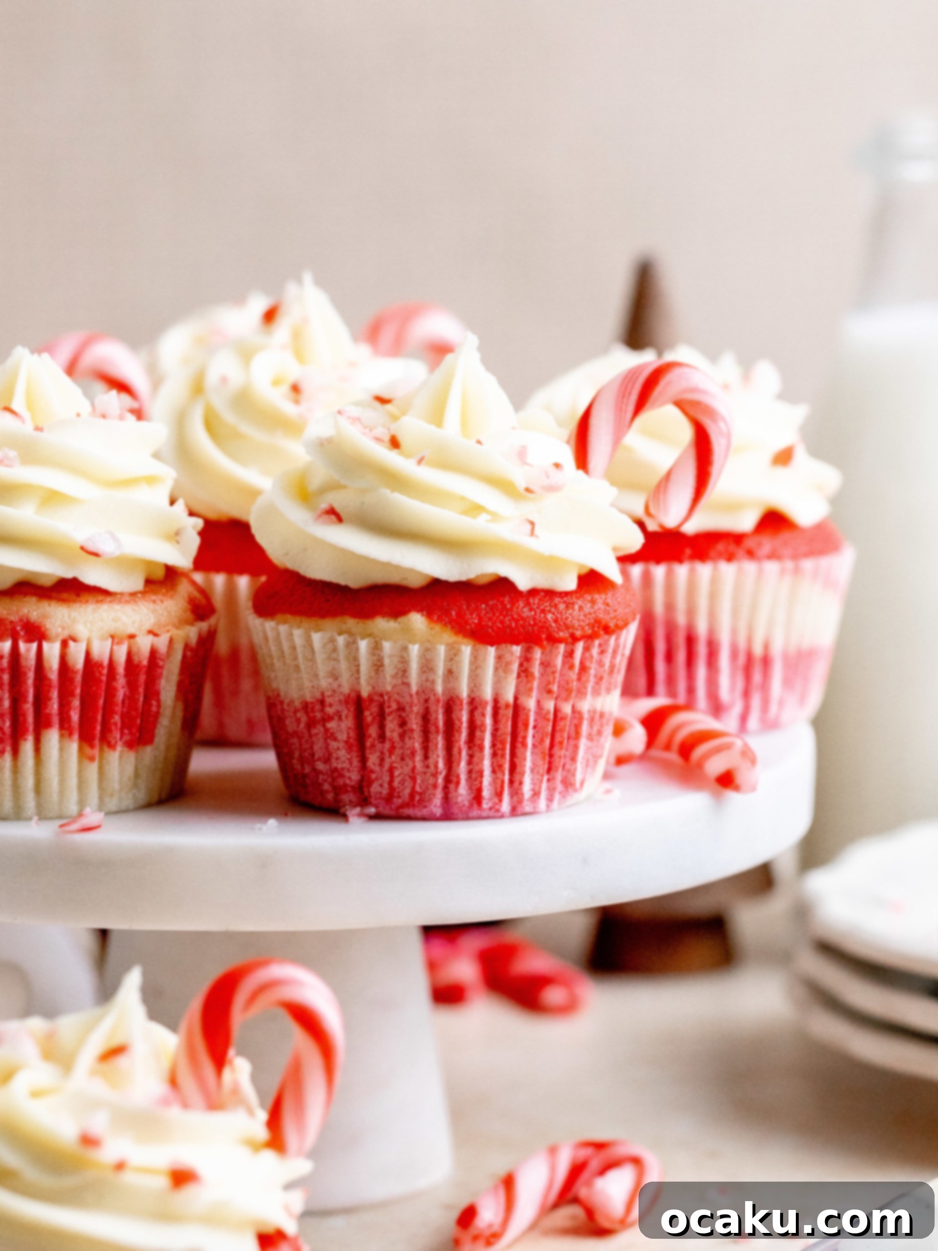 White Chocolate Peppermint Cupcakes topped with frosting and candy canes, ready for the holidays.