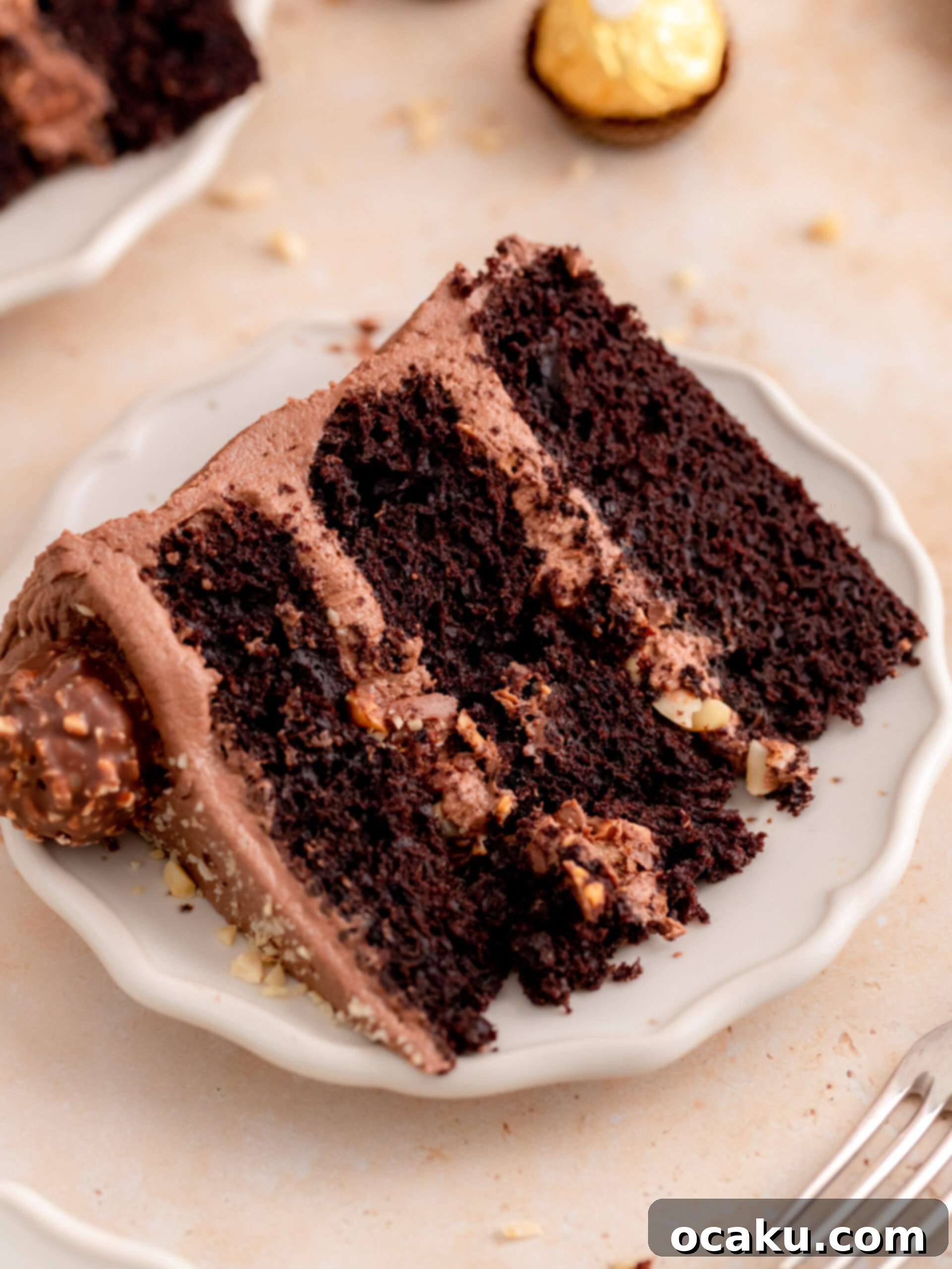 Ferrero Rocher Chocolate Hazelnut Cake 10 A top-down view of a beautifully frosted Ferrero Rocher cake on a stand, ready to be served.