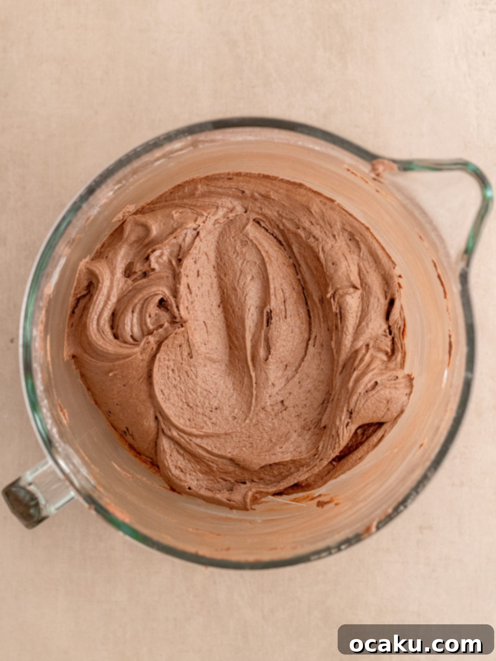 Ferrero Rocher Chocolate Hazelnut Cake 7 Ferrero Rocher cake assembly, showing buttercream and chopped candies between layers.