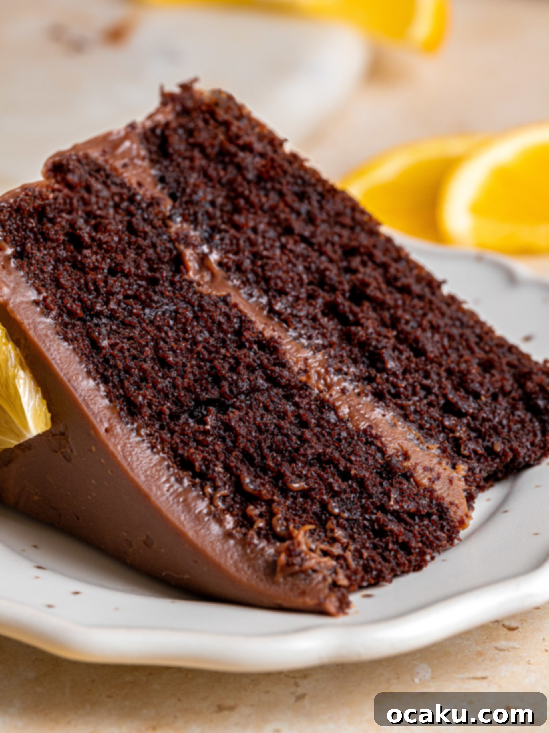 A close-up of the assembled chocolate orange cake with orange slices, ready to be served.