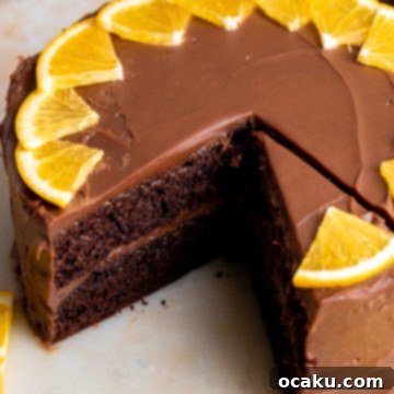 A slice of chocolate orange cake on a plate, ready to be enjoyed.