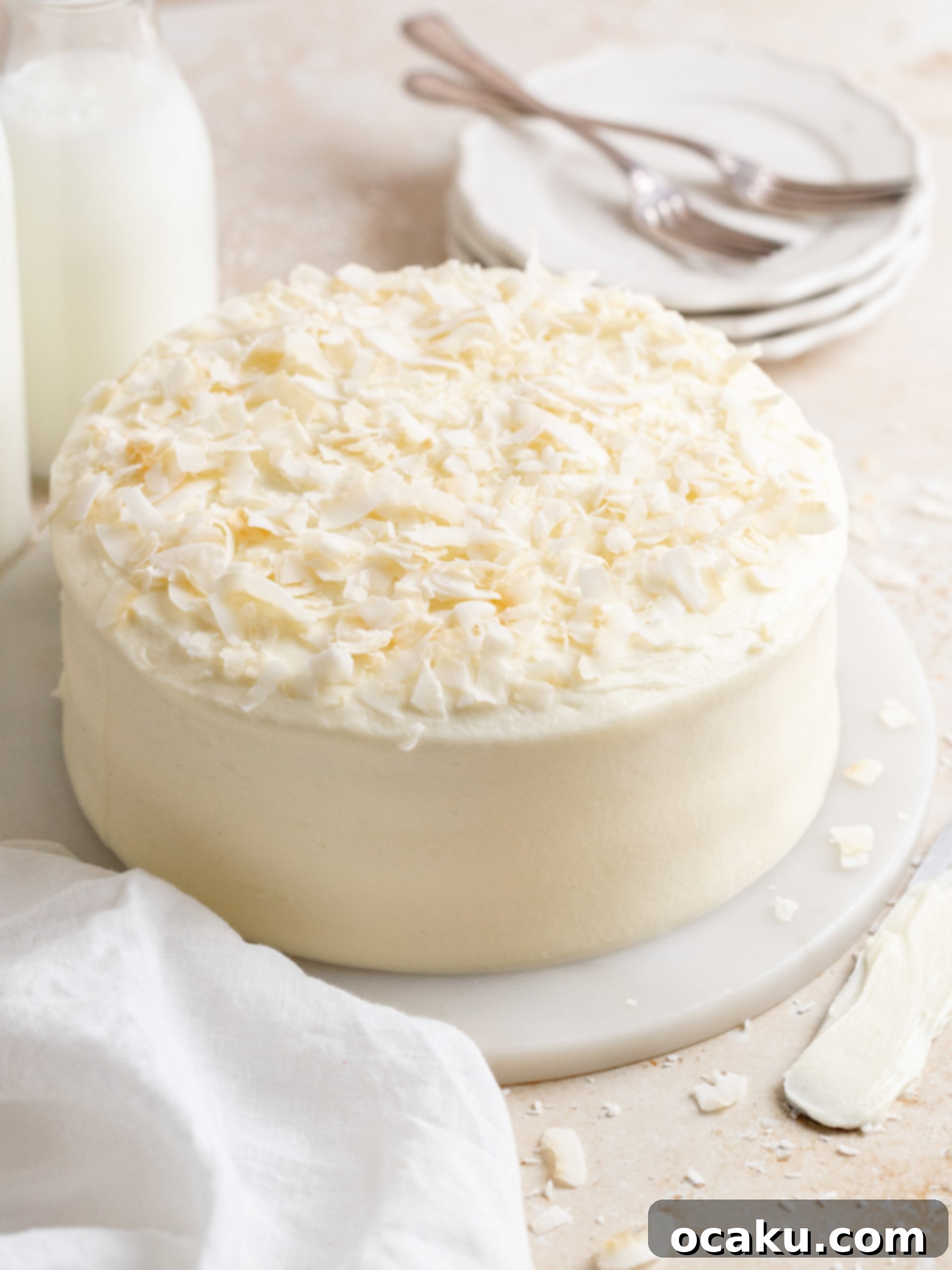Ultimate Coconut Cloud Cake 3 Close-up of a slice of coconut cake showing the moist layers and creamy frosting