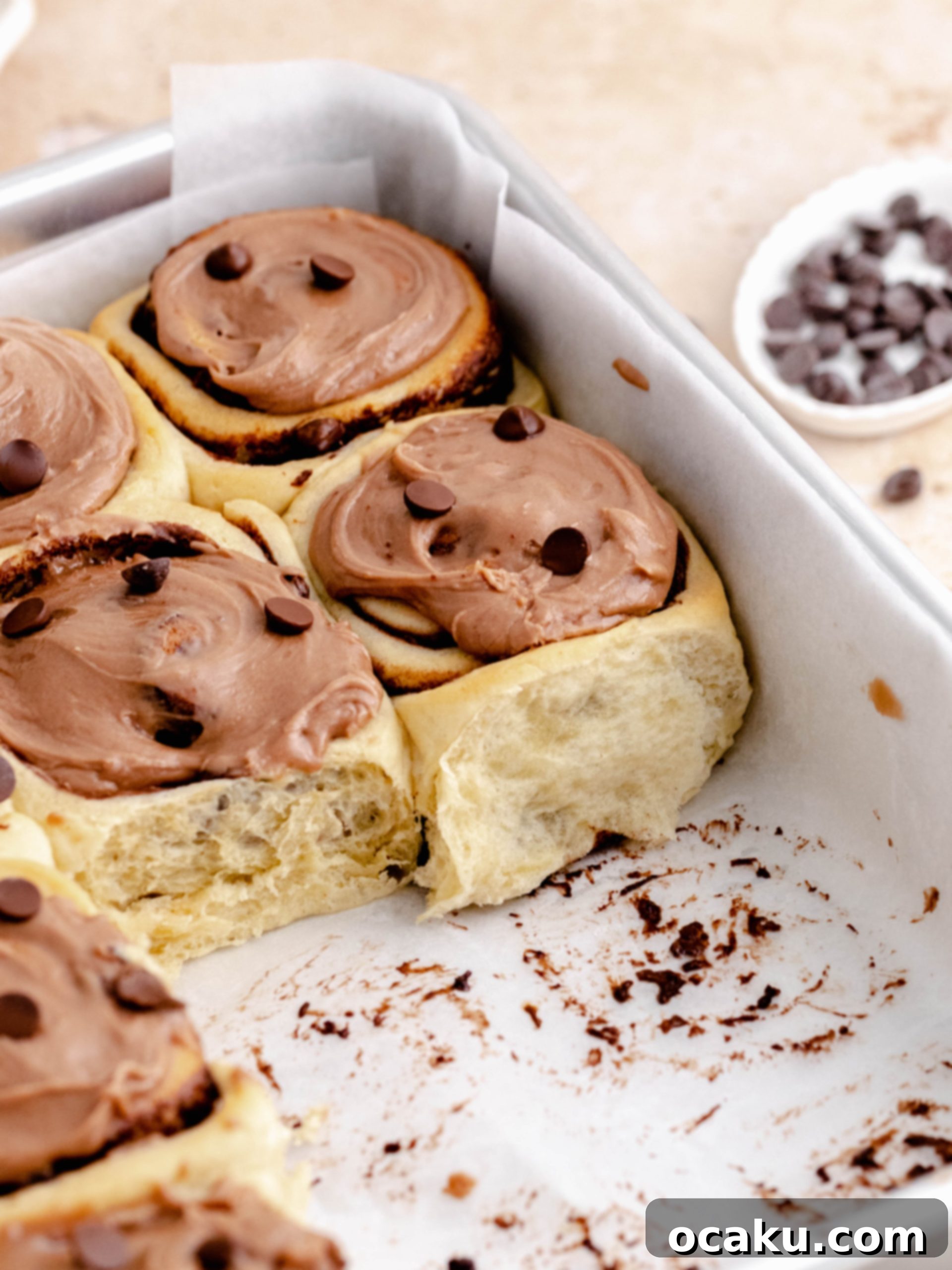 Decadent Nutella Swirls 6 Close-up of frosted Nutella rolls in the baking pan, ready to be served.