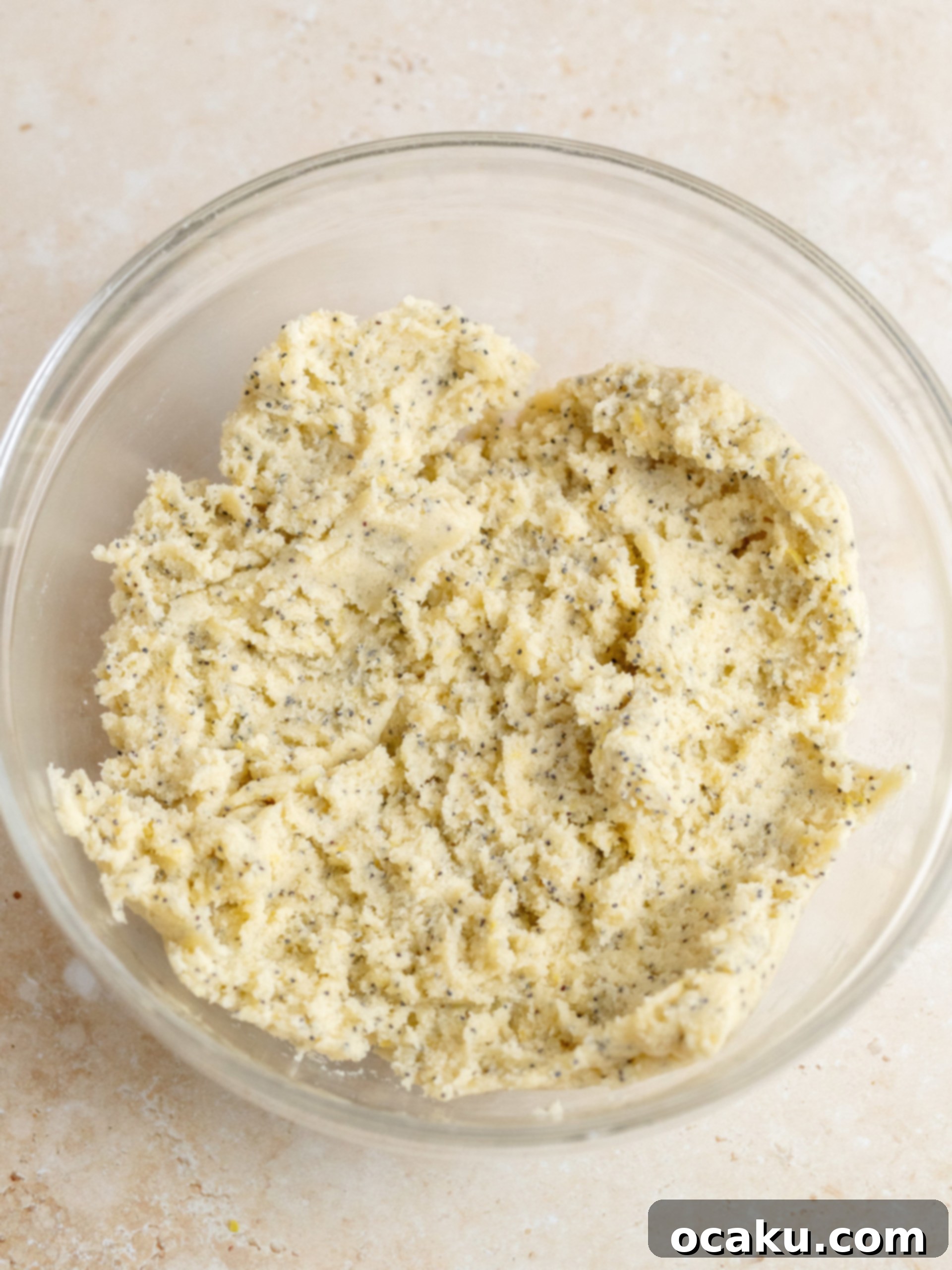 Cookie dough being scooped onto a baking sheet, ready for the oven.