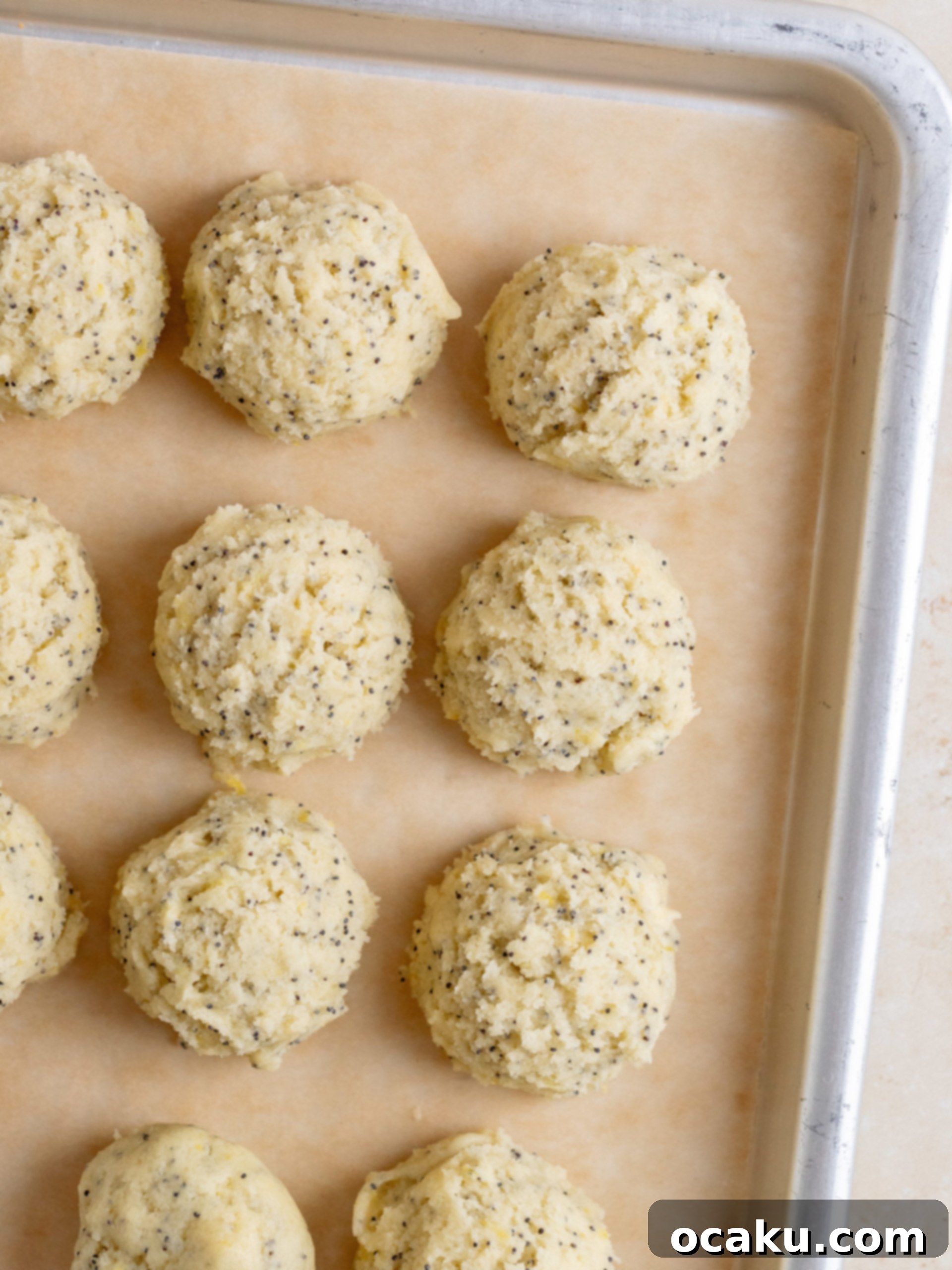 Another image of cookie dough balls on a baking sheet before baking.