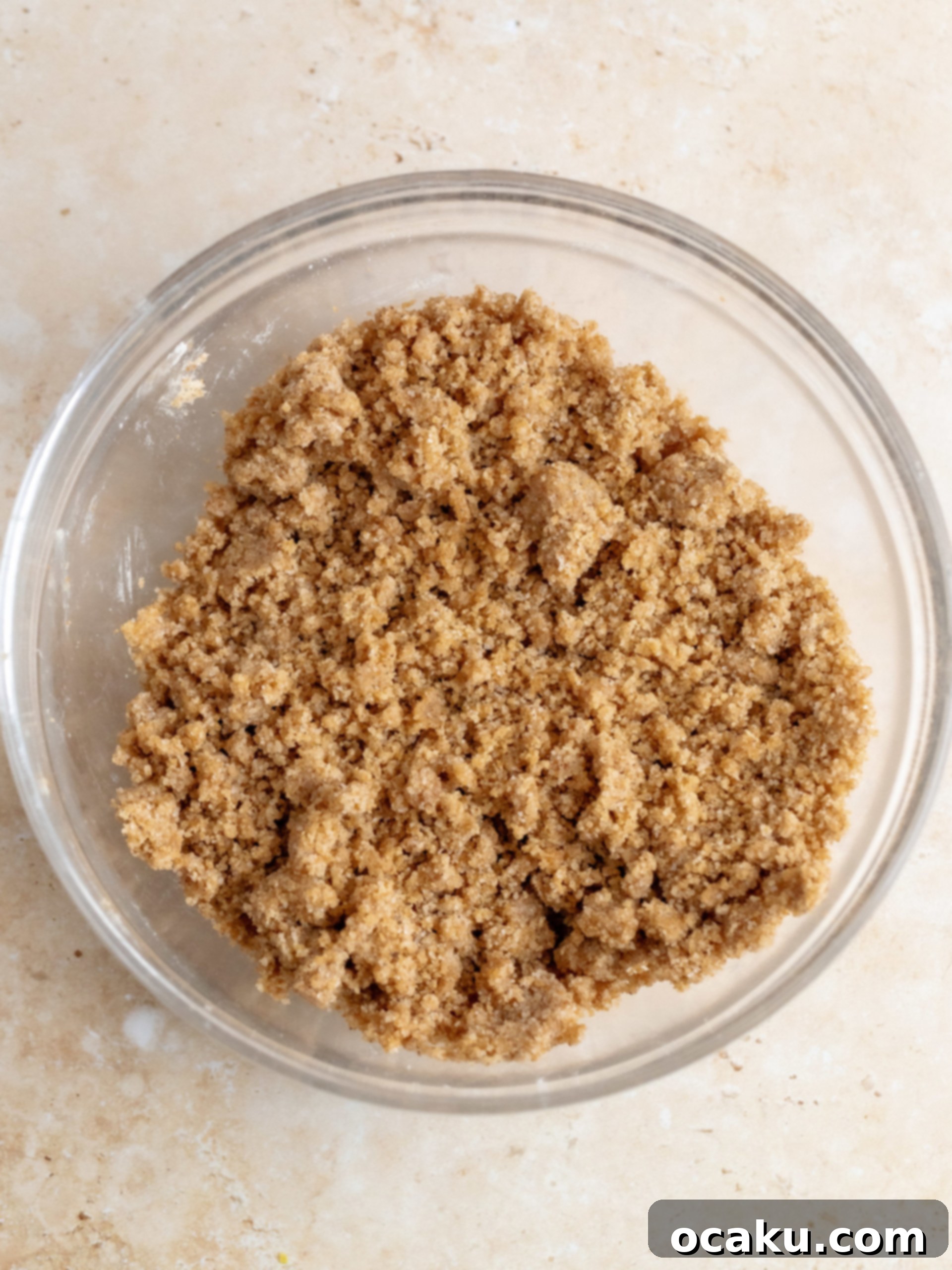 Wet ingredients, including sour cream, vegetable oil, lemon zest, and vanilla extract, being added to the cake batter.