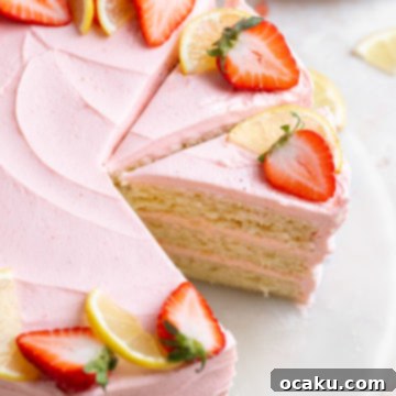 A stunning Strawberry Lemon Cake decorated with fresh fruit.