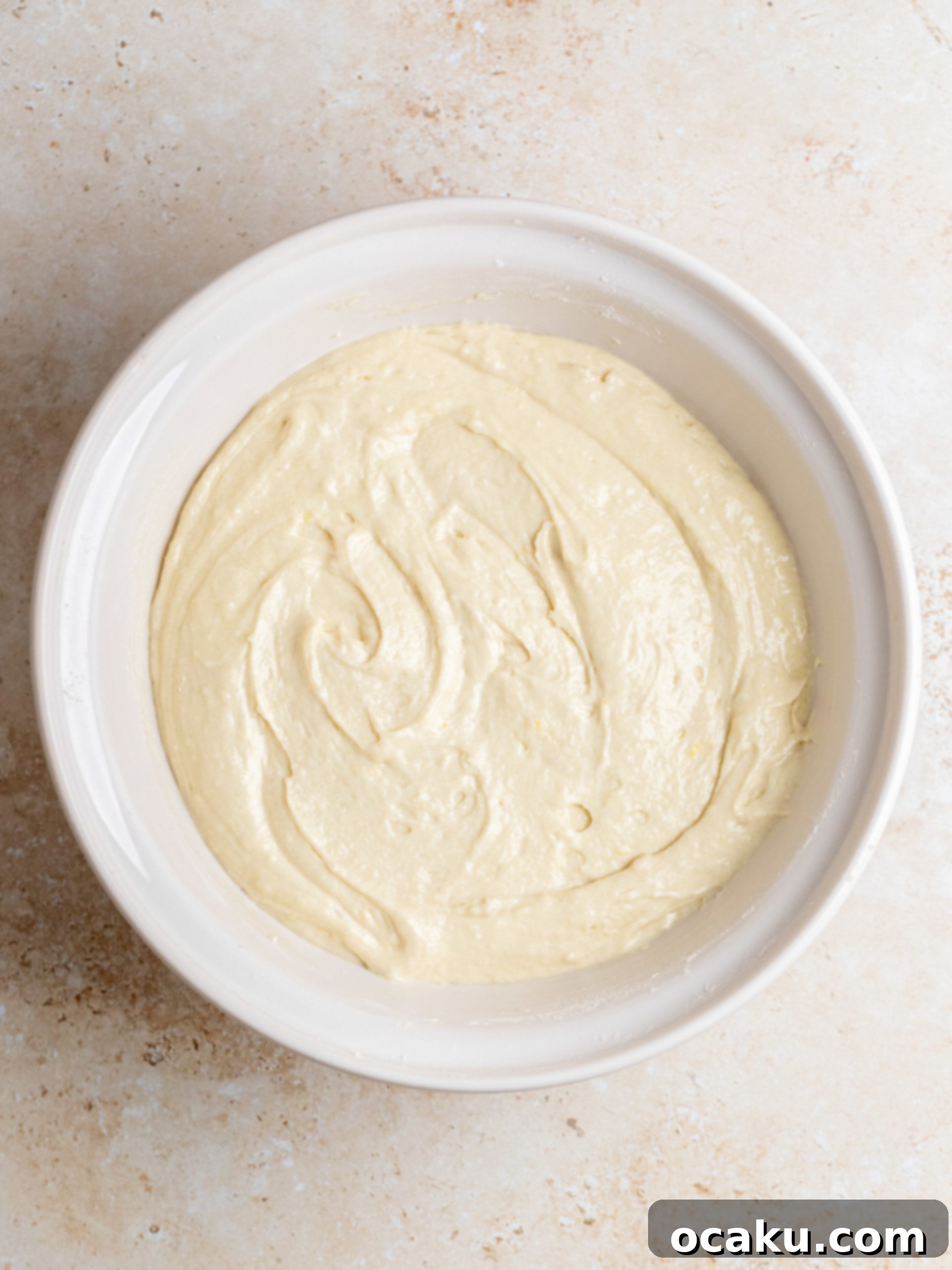 Step-by-step image of mixing cake batter ingredients.