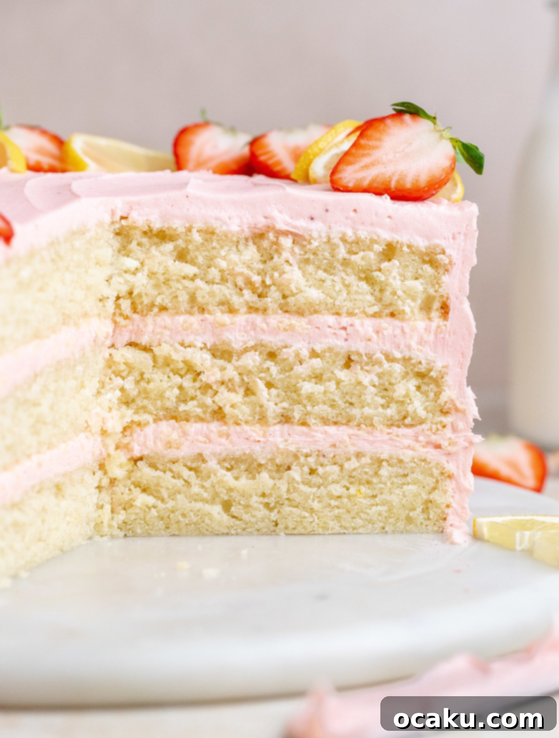 Close-up of the elegant strawberry lemon cake with fresh strawberries and lemon slices.