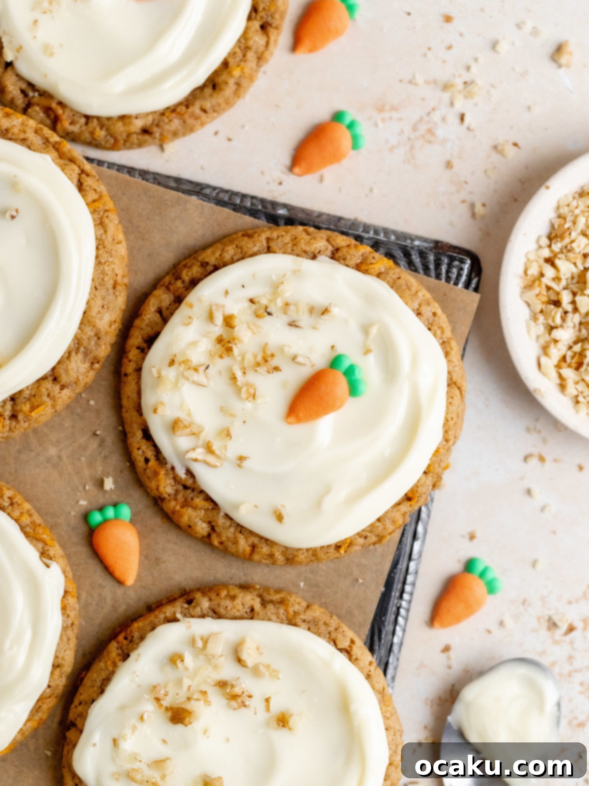 A plate of freshly baked carrot cake cookies with cream cheese frosting and walnuts.