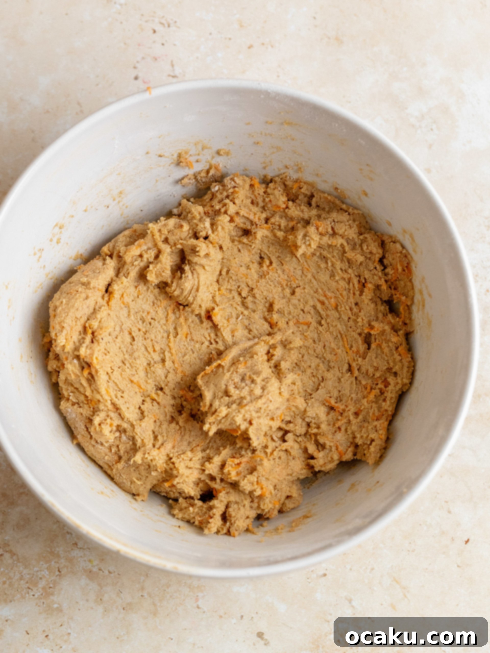 Close-up of butter and sugars creaming in a mixing bowl.