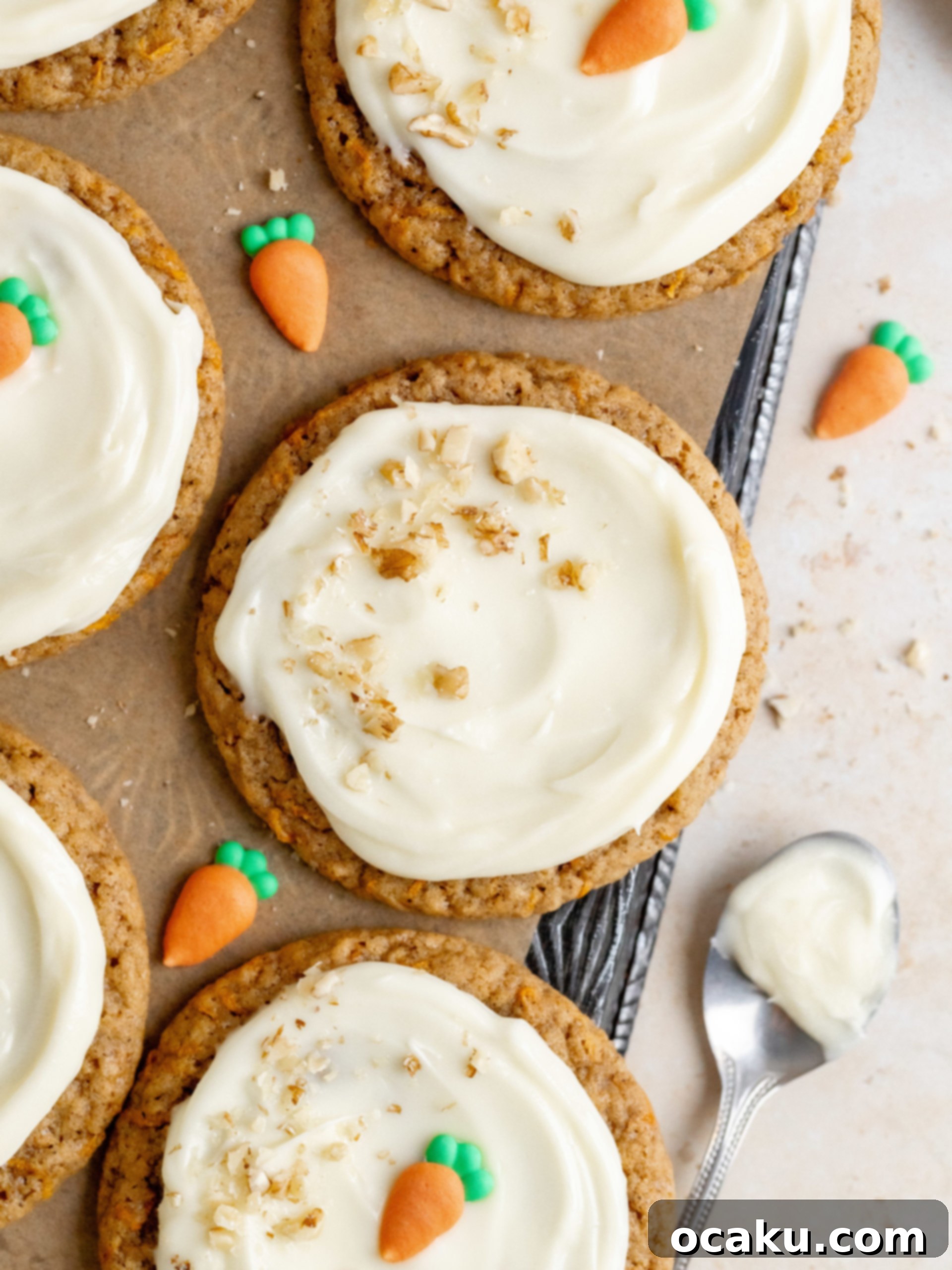A close-up of a beautifully frosted carrot cake cookie with walnuts.