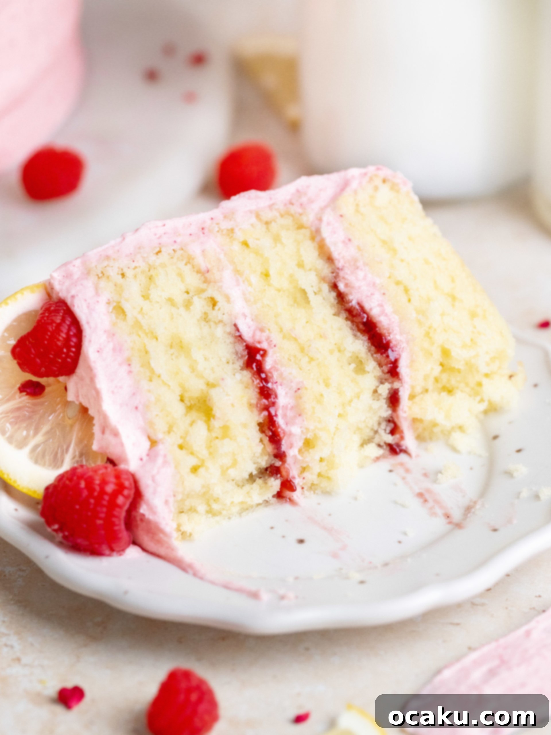 A top-down view of the decorated lemon raspberry cake, highlighting the fresh fruit garnishes.