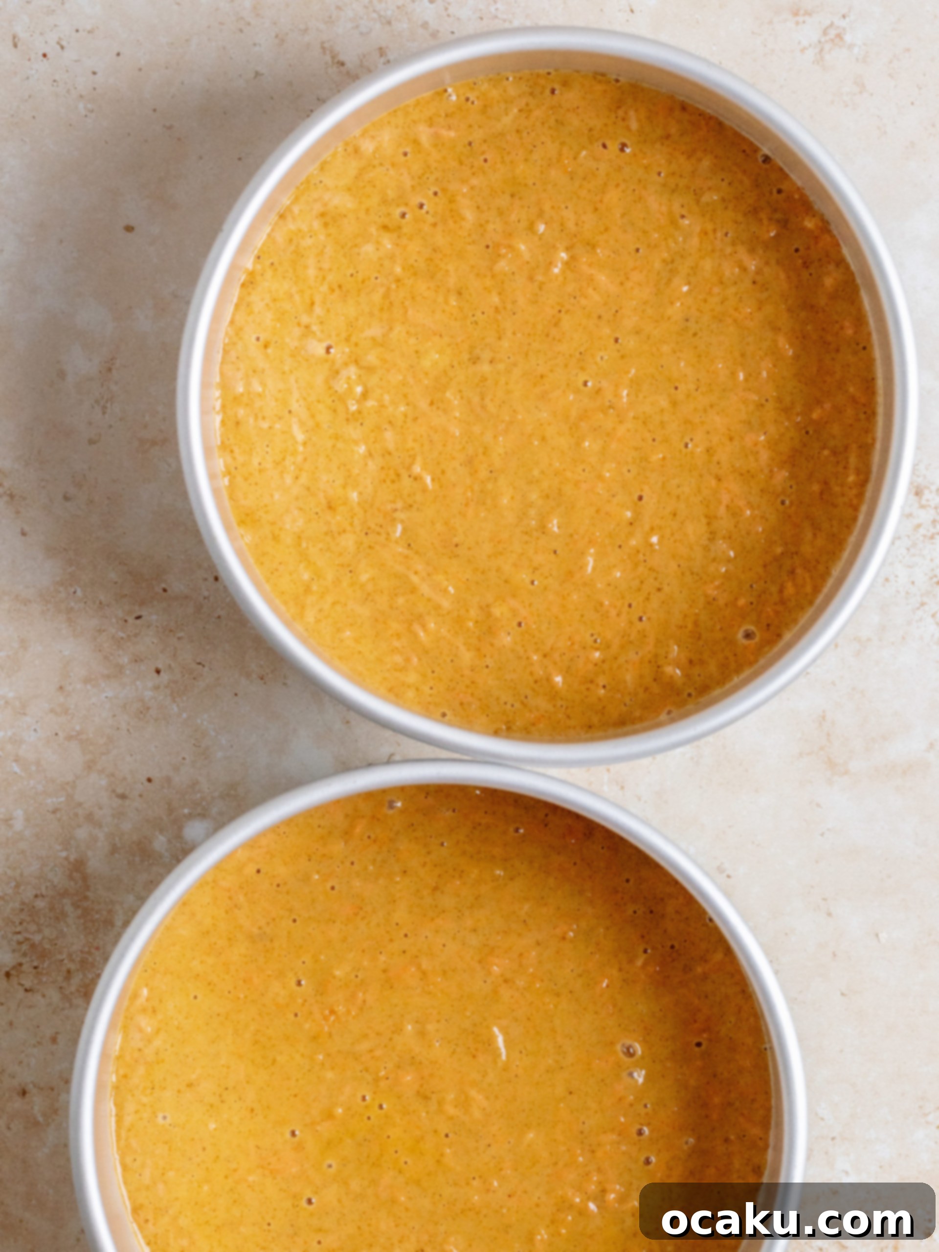 Applying cream cheese frosting to cake