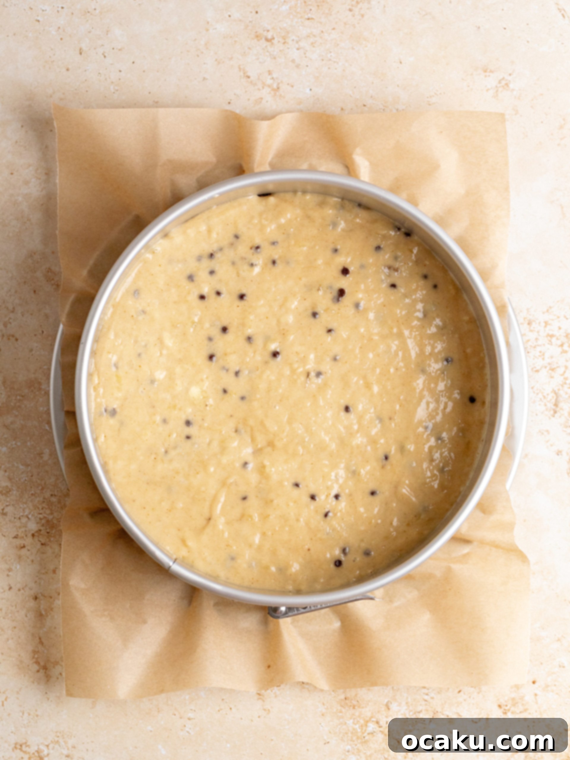 Cinnamon streusel being sprinkled over the banana coffee cake batter