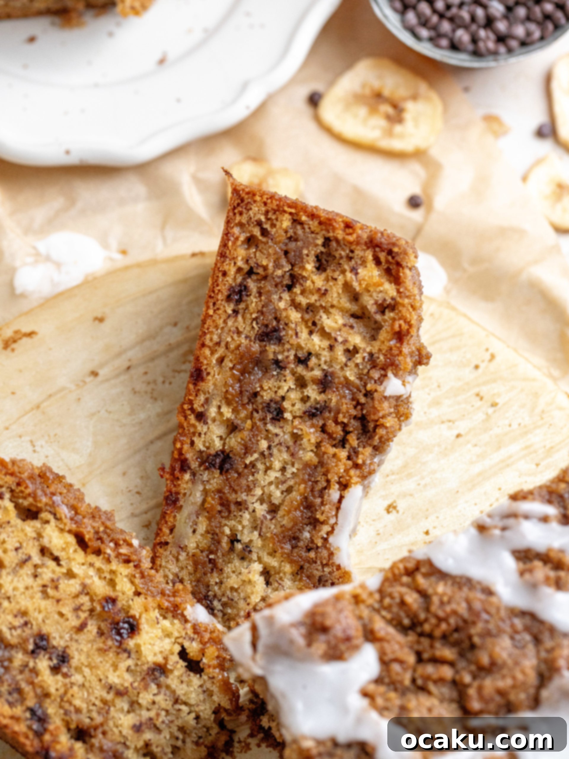 A slice of brown butter banana coffee cake on a plate with a fork