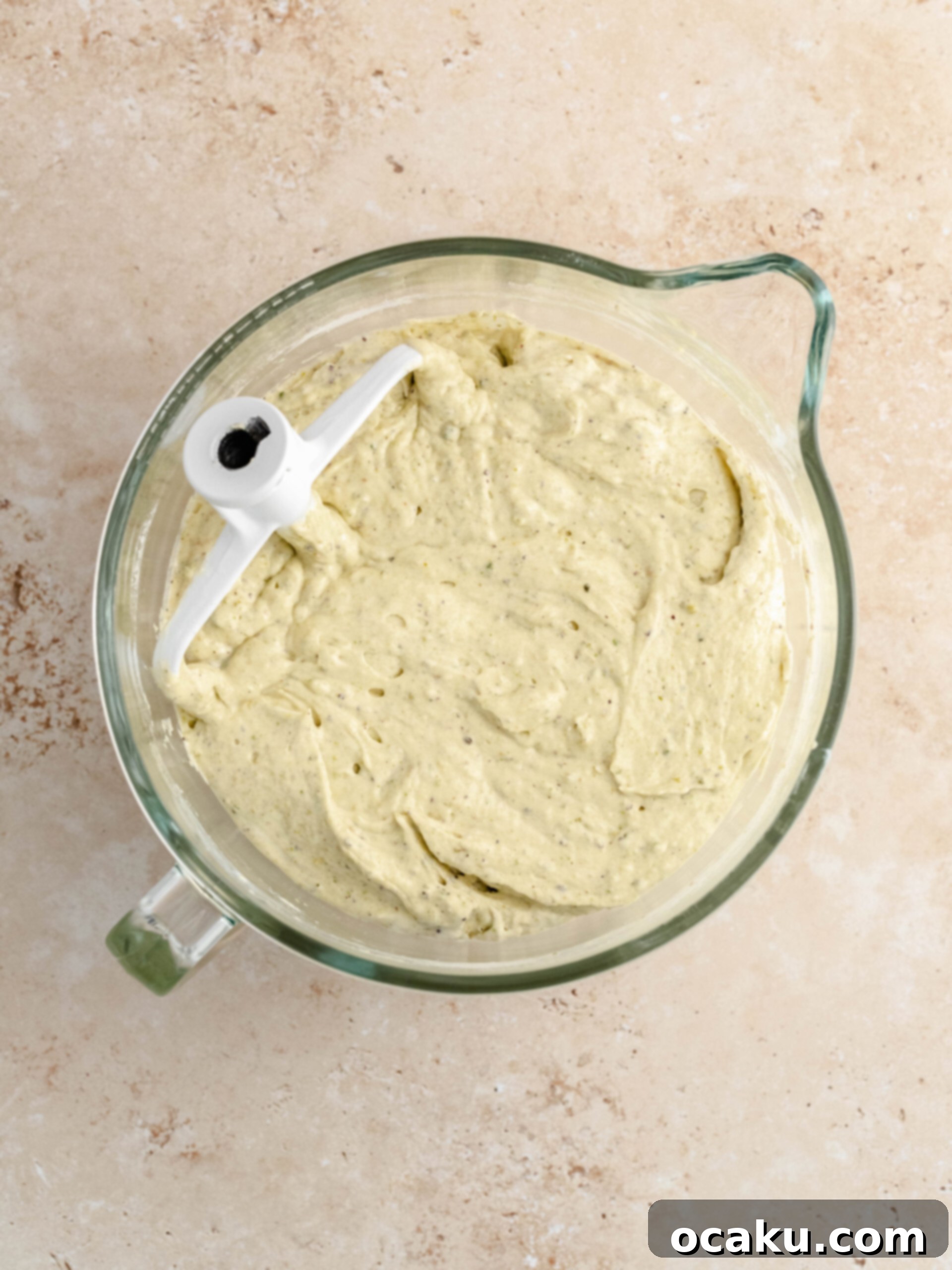 Zesty Lemon Pistachio Cake 3 Close-up of the bright green pistachio cake batter in a baking pan before going into the oven.