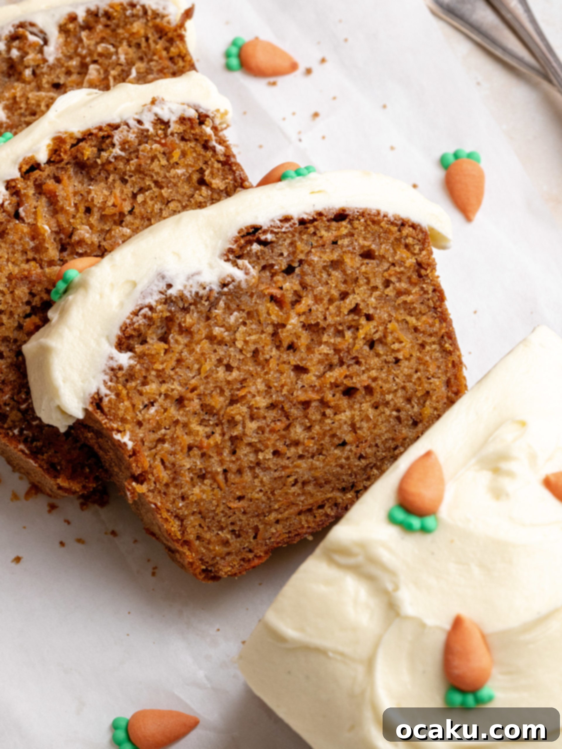A moist carrot cake loaf topped with a generous layer of cream cheese frosting