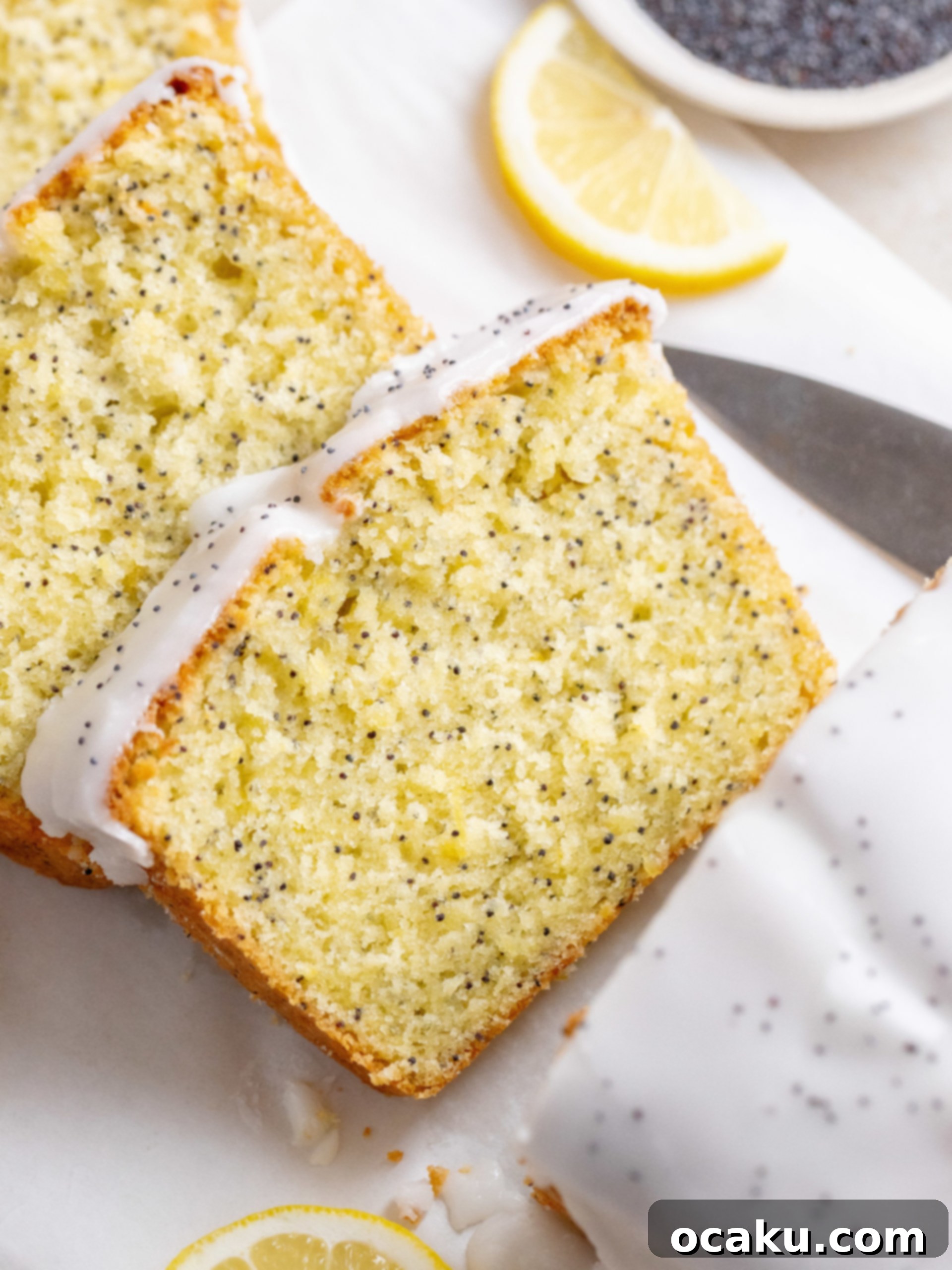 A delicate lemon poppy seed pound cake drizzled generously with bright lemon icing