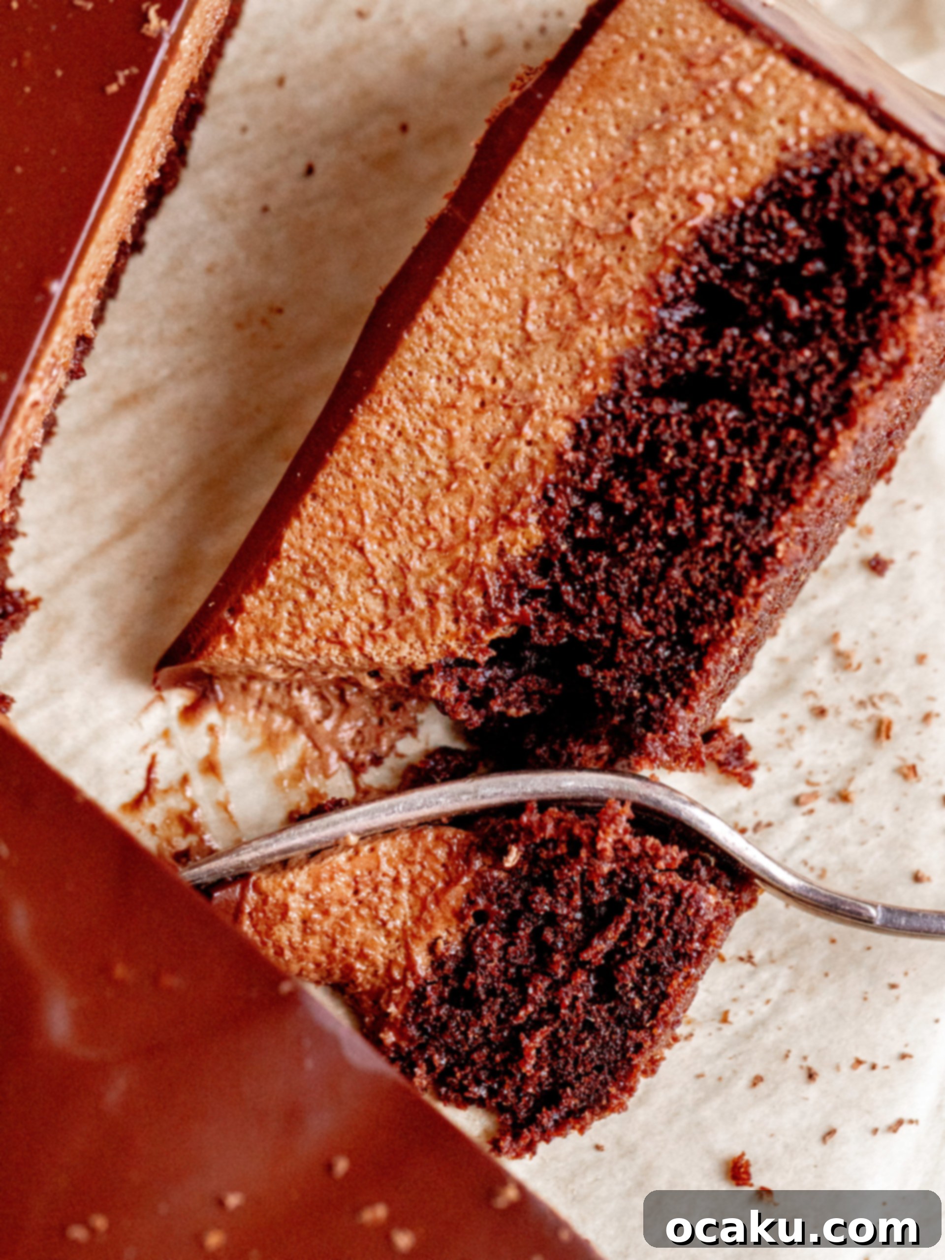 Decadent Chocolate Mousse Cake with three layers of chocolate, topped with glossy ganache.