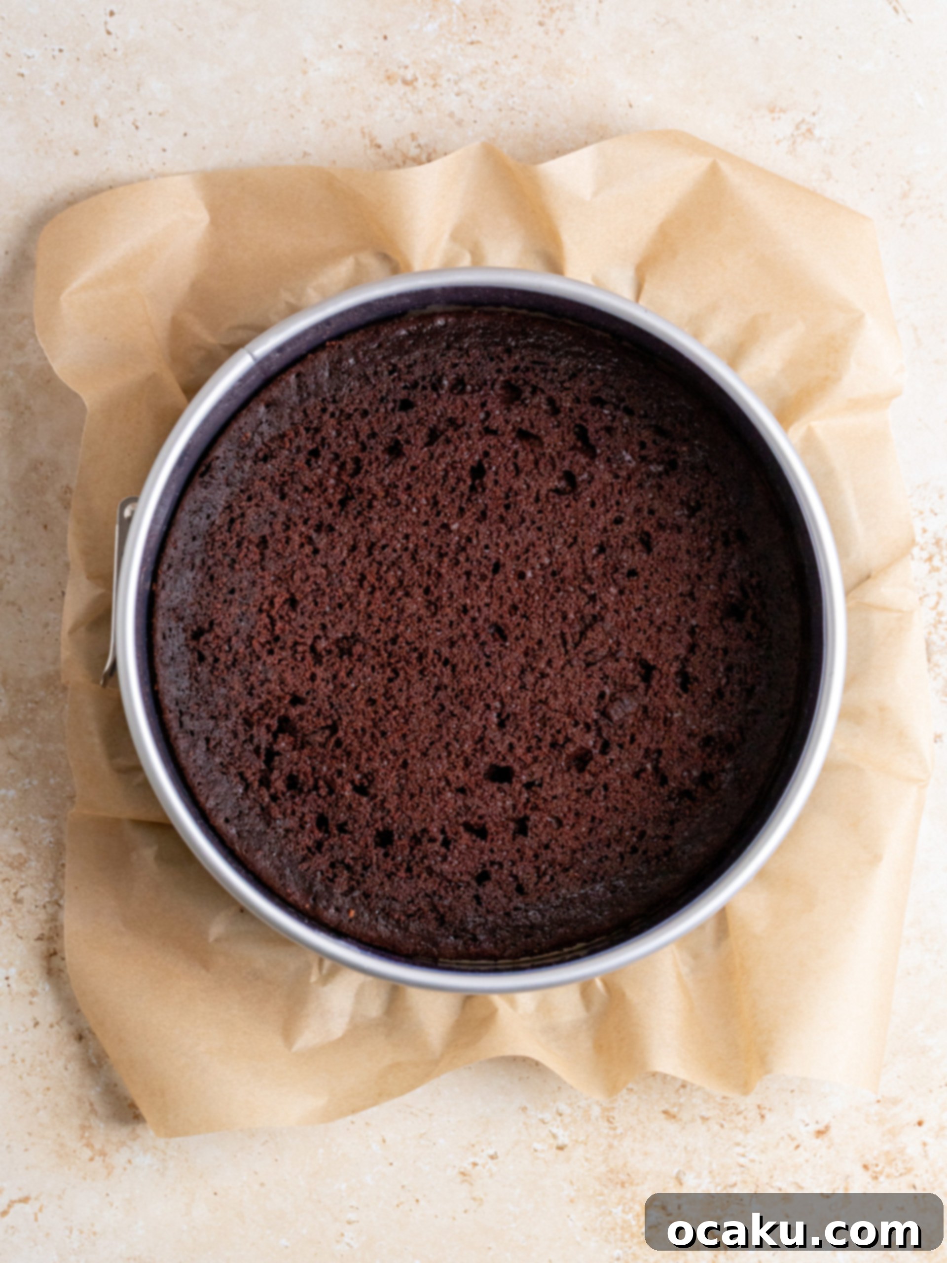 Pouring mousse over chocolate cake base.