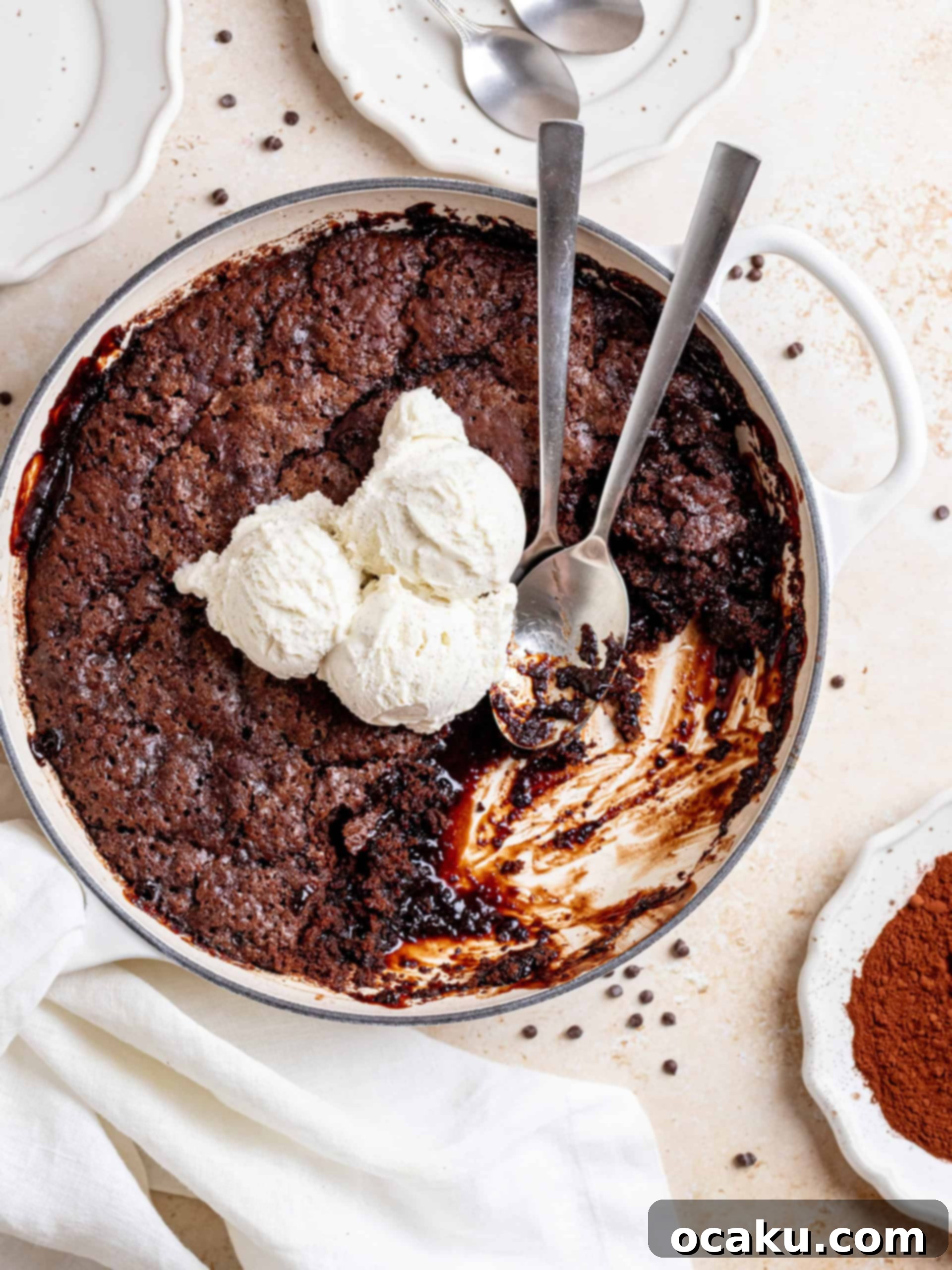 A beautifully presented slice of warm Brown Butter Hot Fudge Cake with melted hot fudge underneath and a scoop of vanilla ice cream on top.
