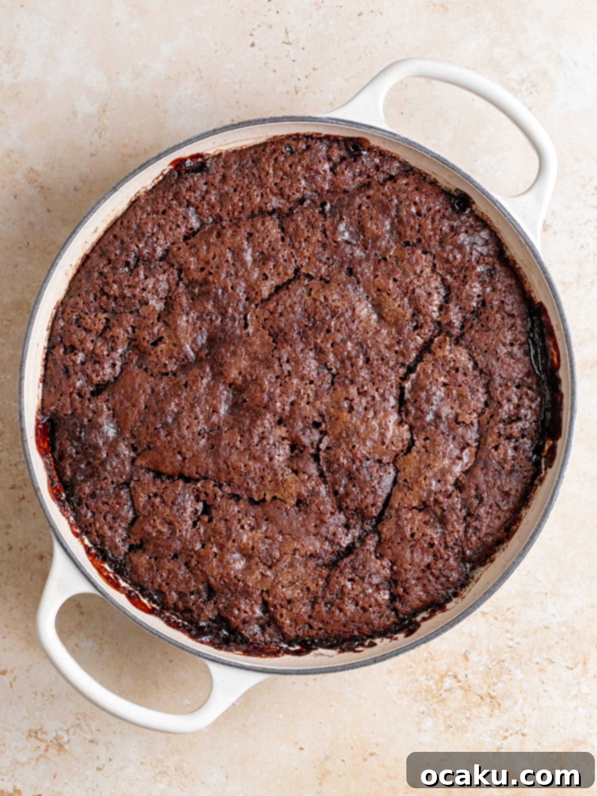 A spoonful of Brown Butter Hot Fudge Cake showing layers of soft cake, gooey fudge, and creamy vanilla ice cream.