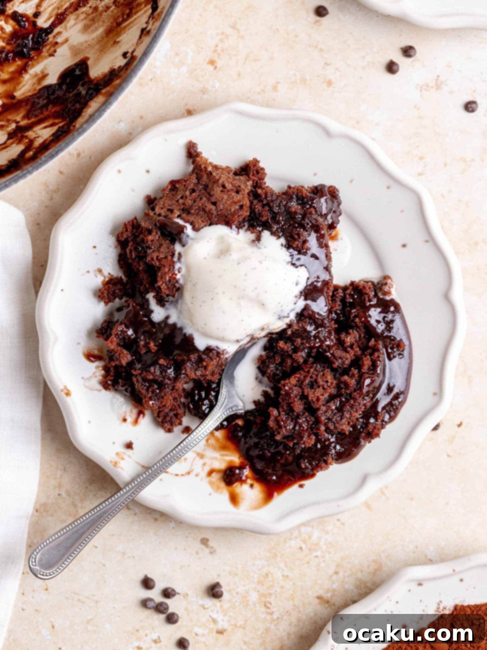 Close-up of the rich, smooth chocolate cake batter in a stainless steel bowl, showing its readiness for baking.