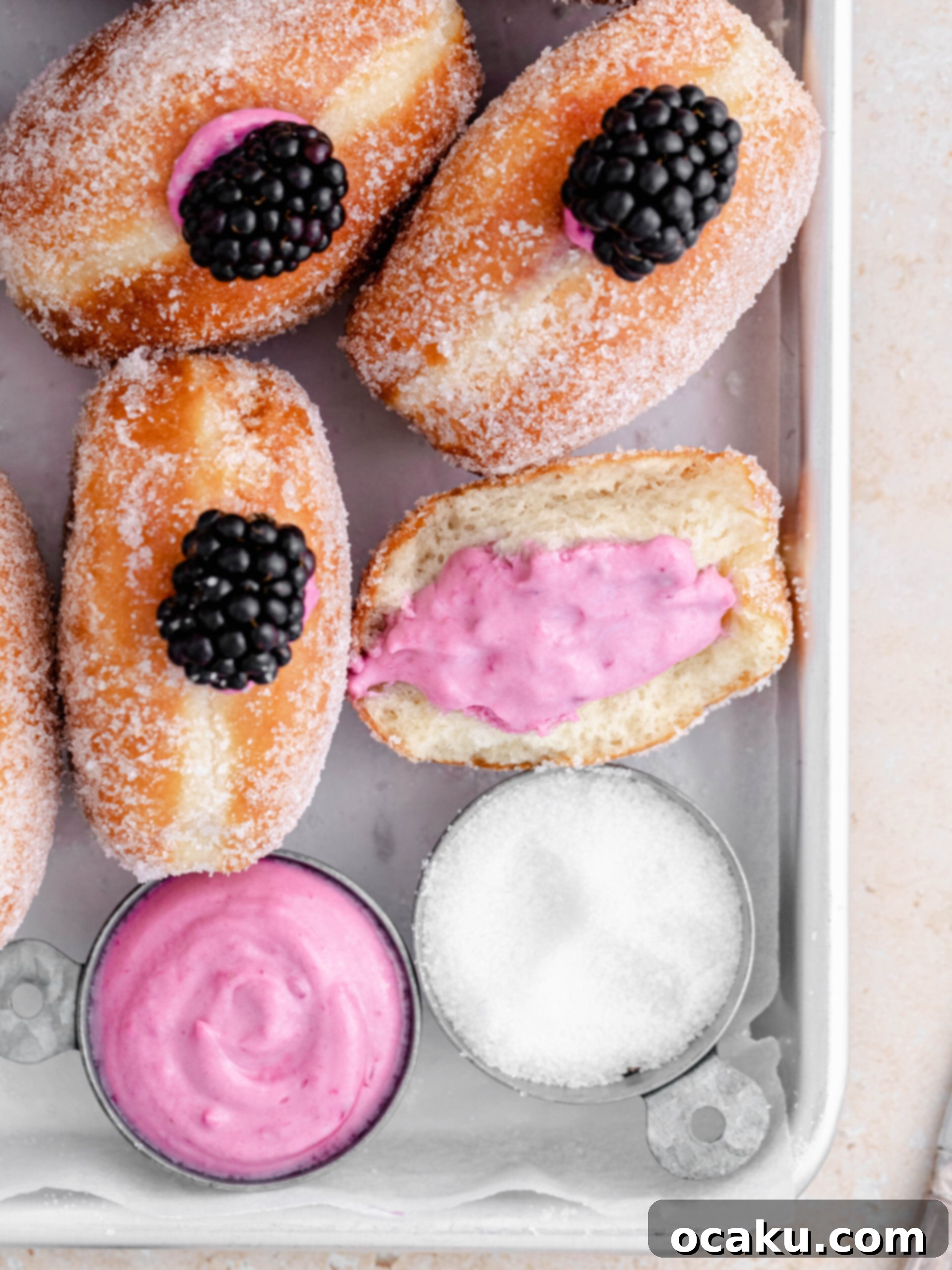 Delicious filled blackberry cheesecake donuts artfully arranged on a serving tray.