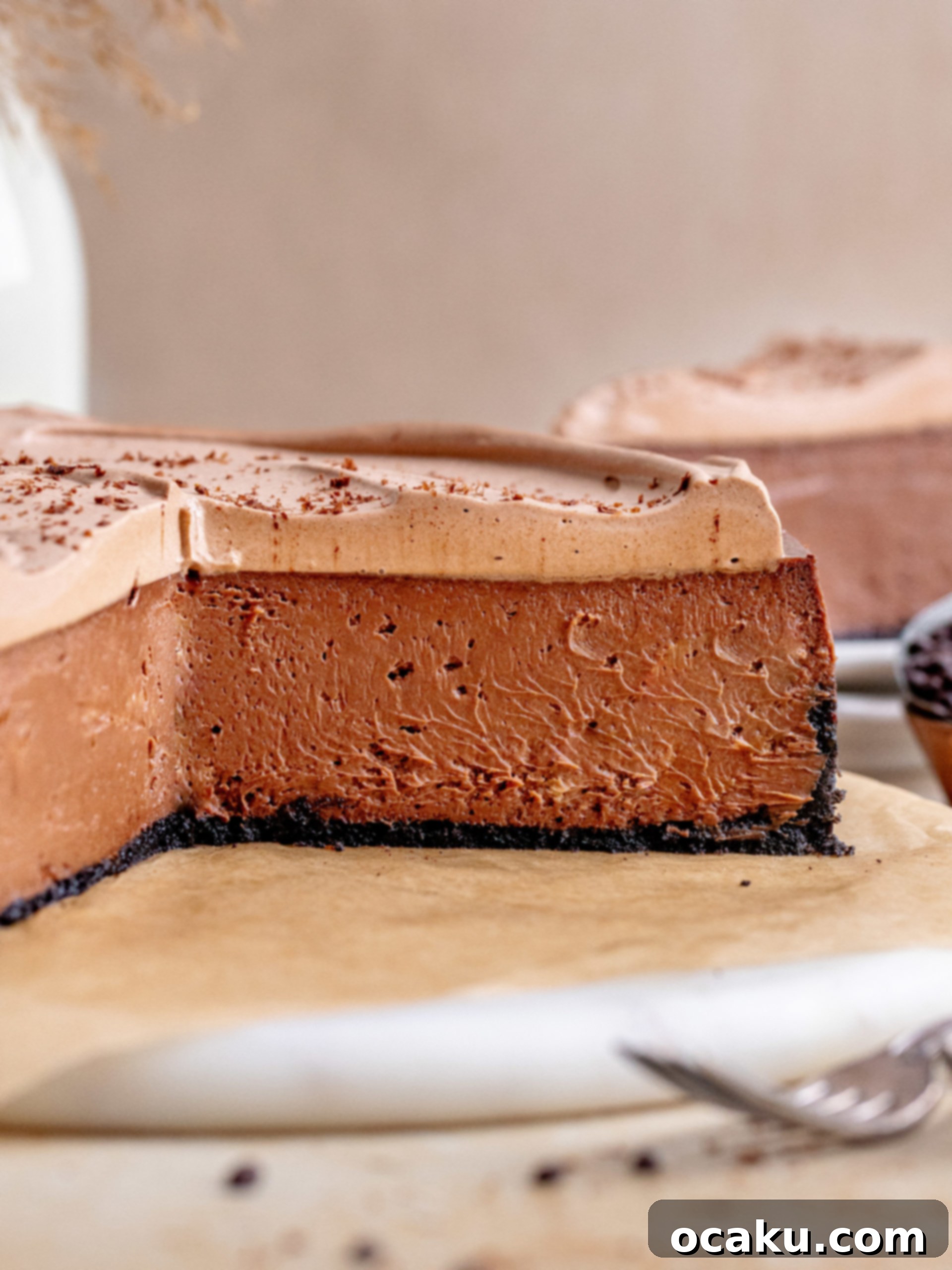 Decadent Chocolate Cheesecake 13 A top-down view of a decadent chocolate cheesecake with a generous swirl of whipped dark chocolate ganache and decorative chocolate shavings.