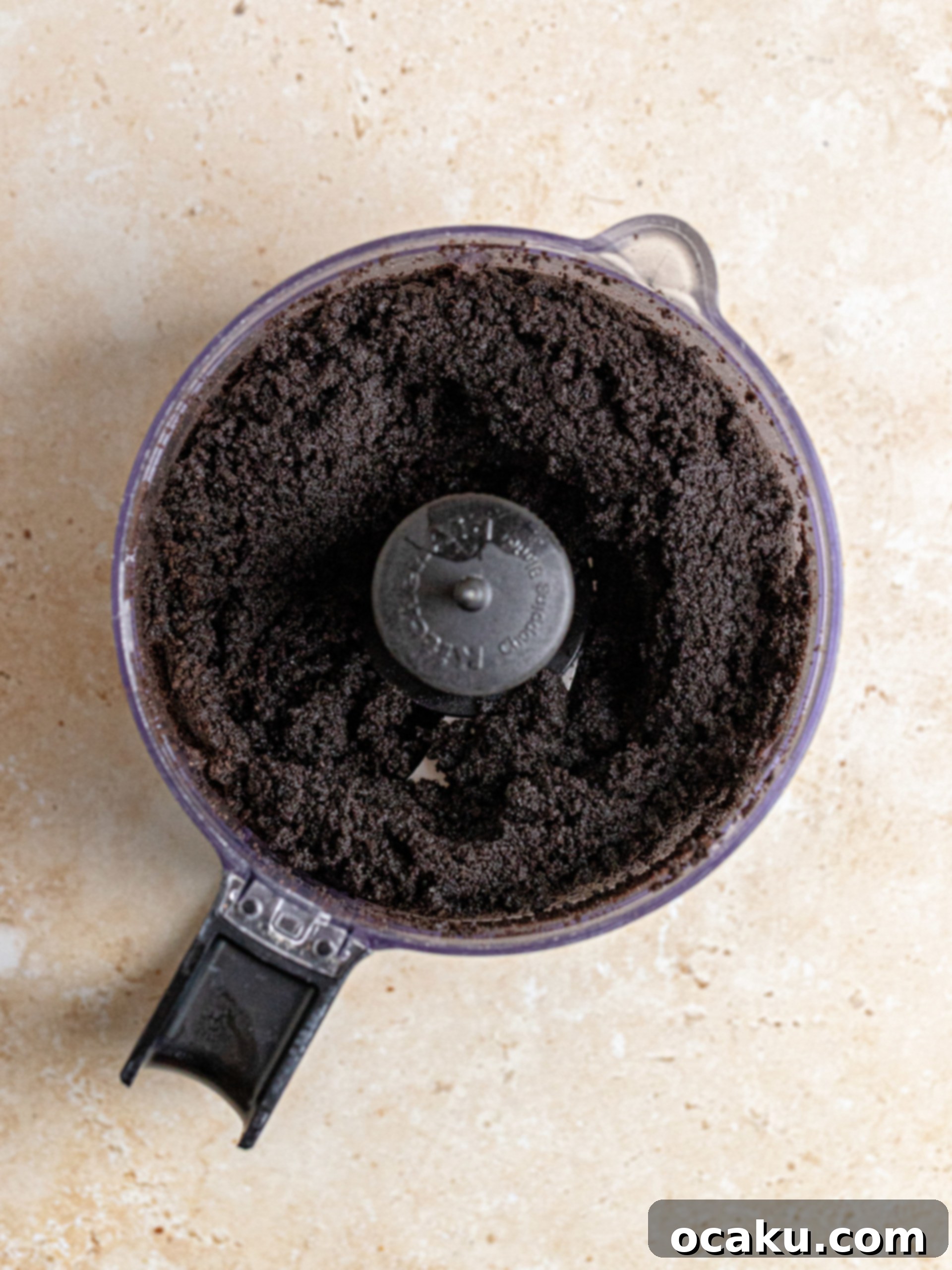 Decadent Chocolate Cheesecake 4 Crushed Oreo cookies mixed with melted butter in a food processor, forming the cheesecake crust ingredients.