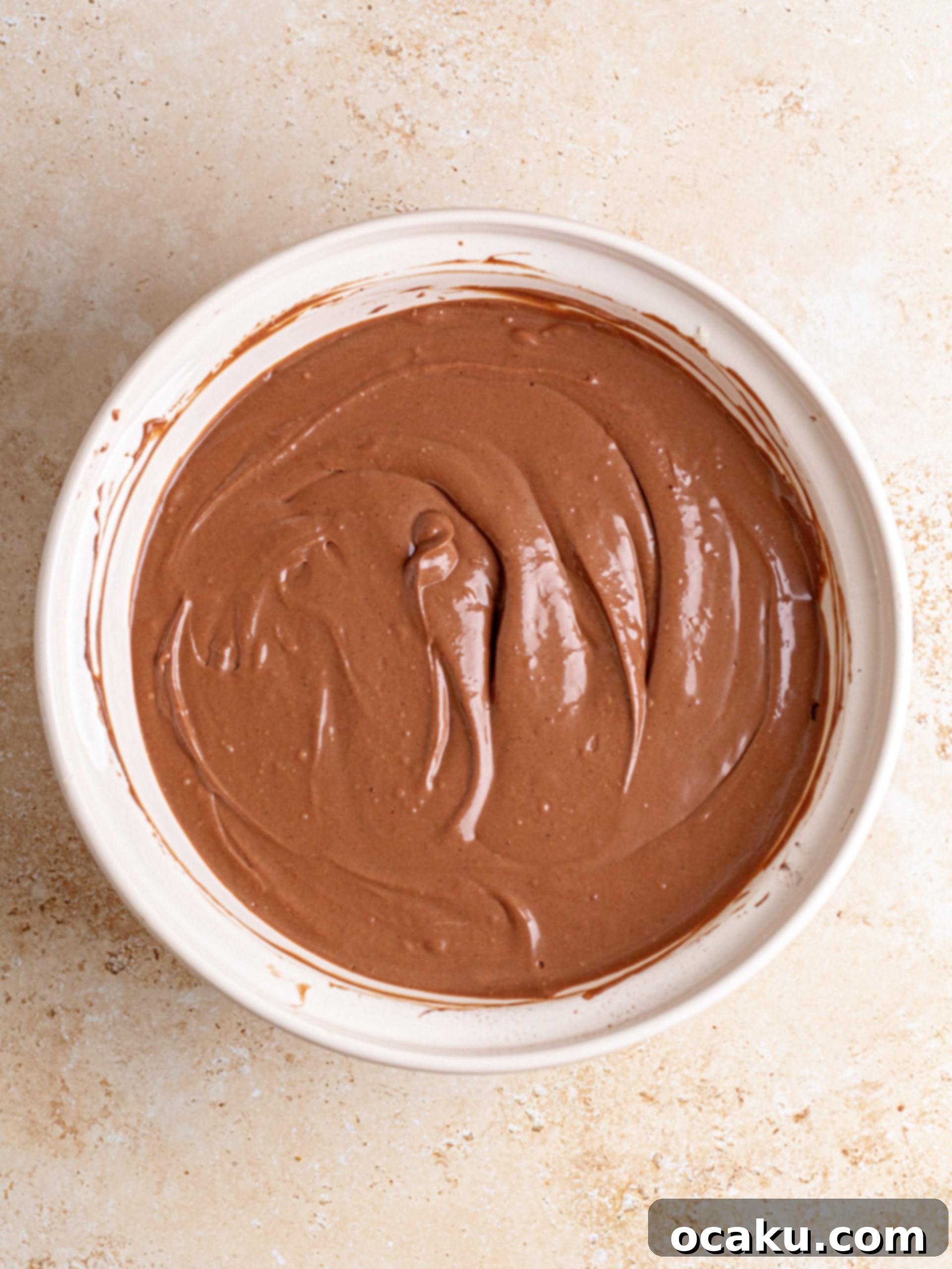 Decadent Chocolate Cheesecake 7 Smooth chocolate cheesecake batter poured into a springform pan, ready for the next step.