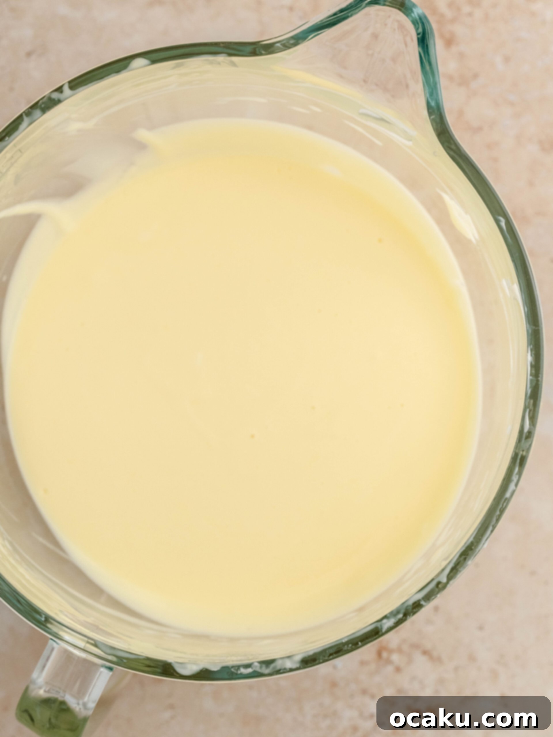 Smooth and creamy cheesecake filling in a stand mixer bowl, ready for assembly.