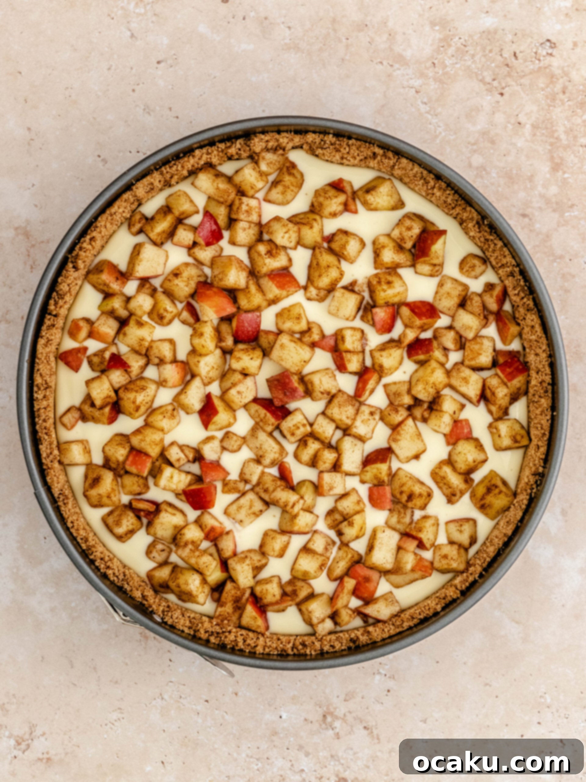 Sweet and spiced diced apples carefully spread over the cheesecake filling.
