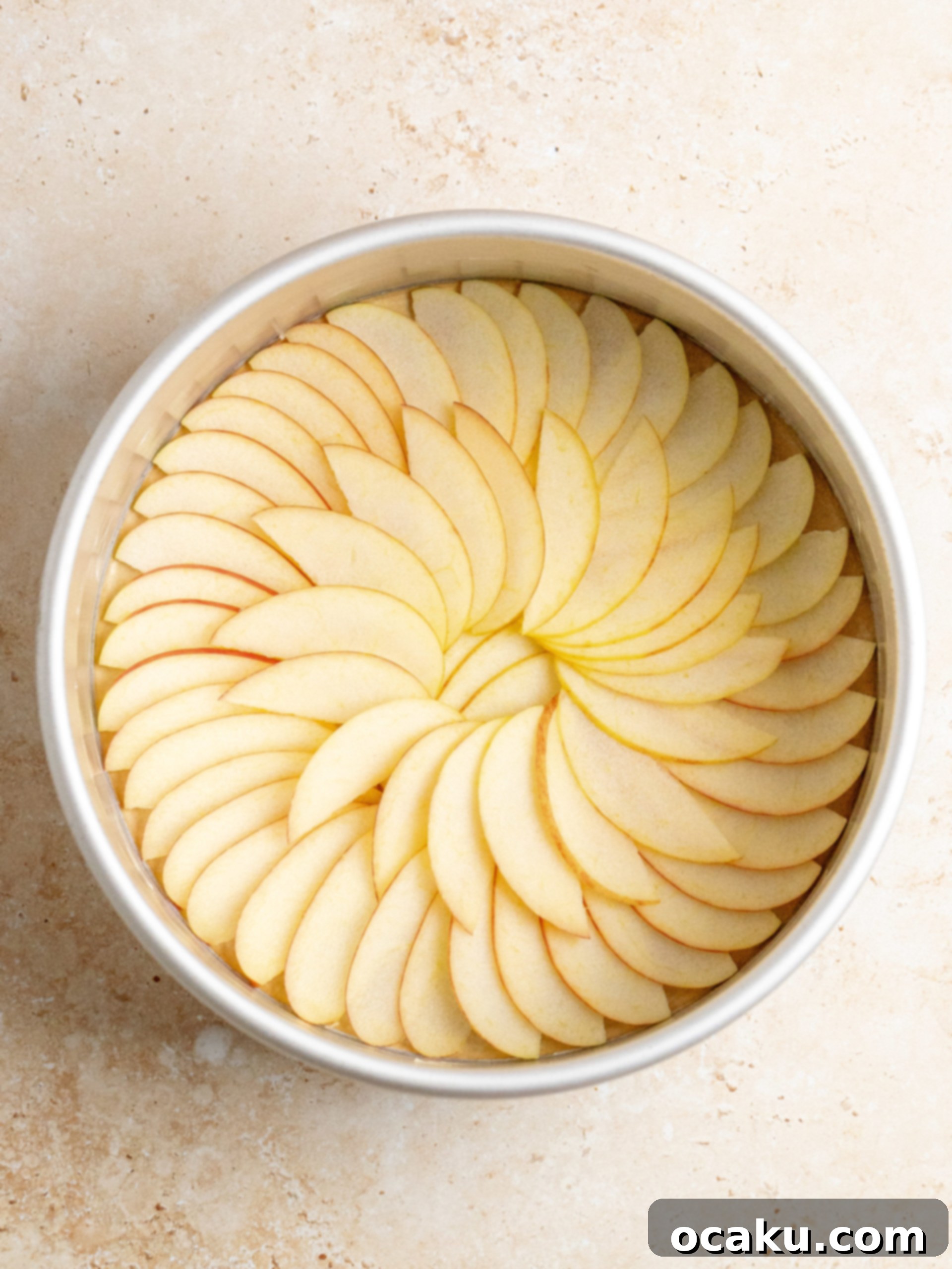 Sliced apples arranged in a baking pan