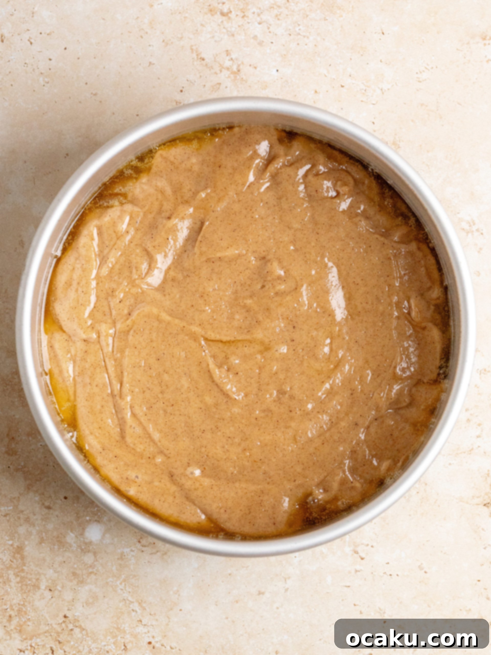 Cake batter poured over apples