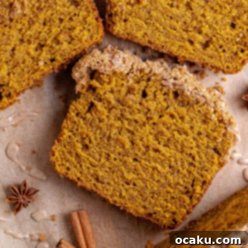 Pumpkin Perfection Loaf with Crumbly Topping and Spice Drizzle 9 A delectable Pumpkin Bread with Streusel Topping and Pumpkin Spice Glaze, ready to be served.