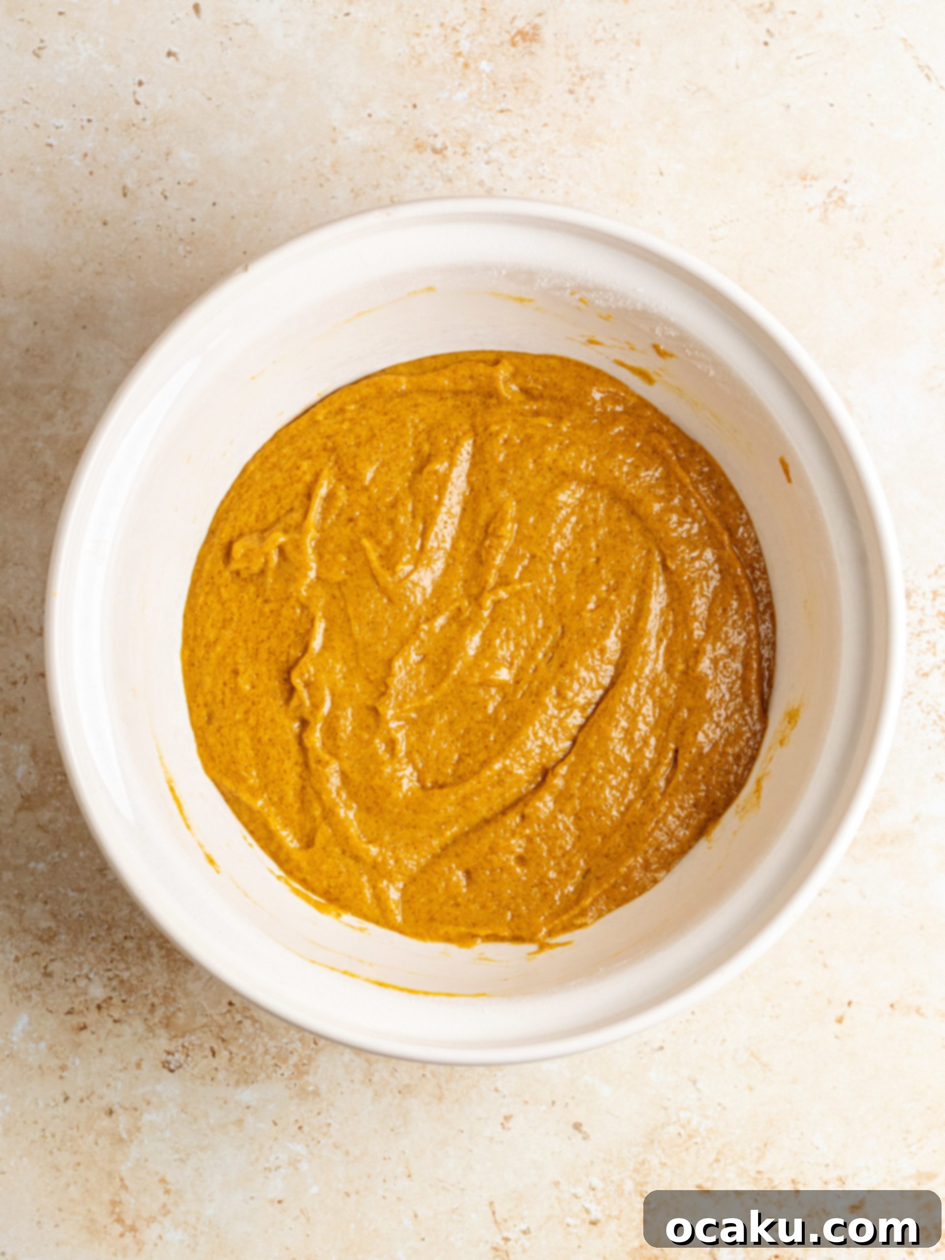 Pumpkin Perfection Loaf with Crumbly Topping and Spice Drizzle 4 Mixing dry ingredients in a large bowl for pumpkin bread.