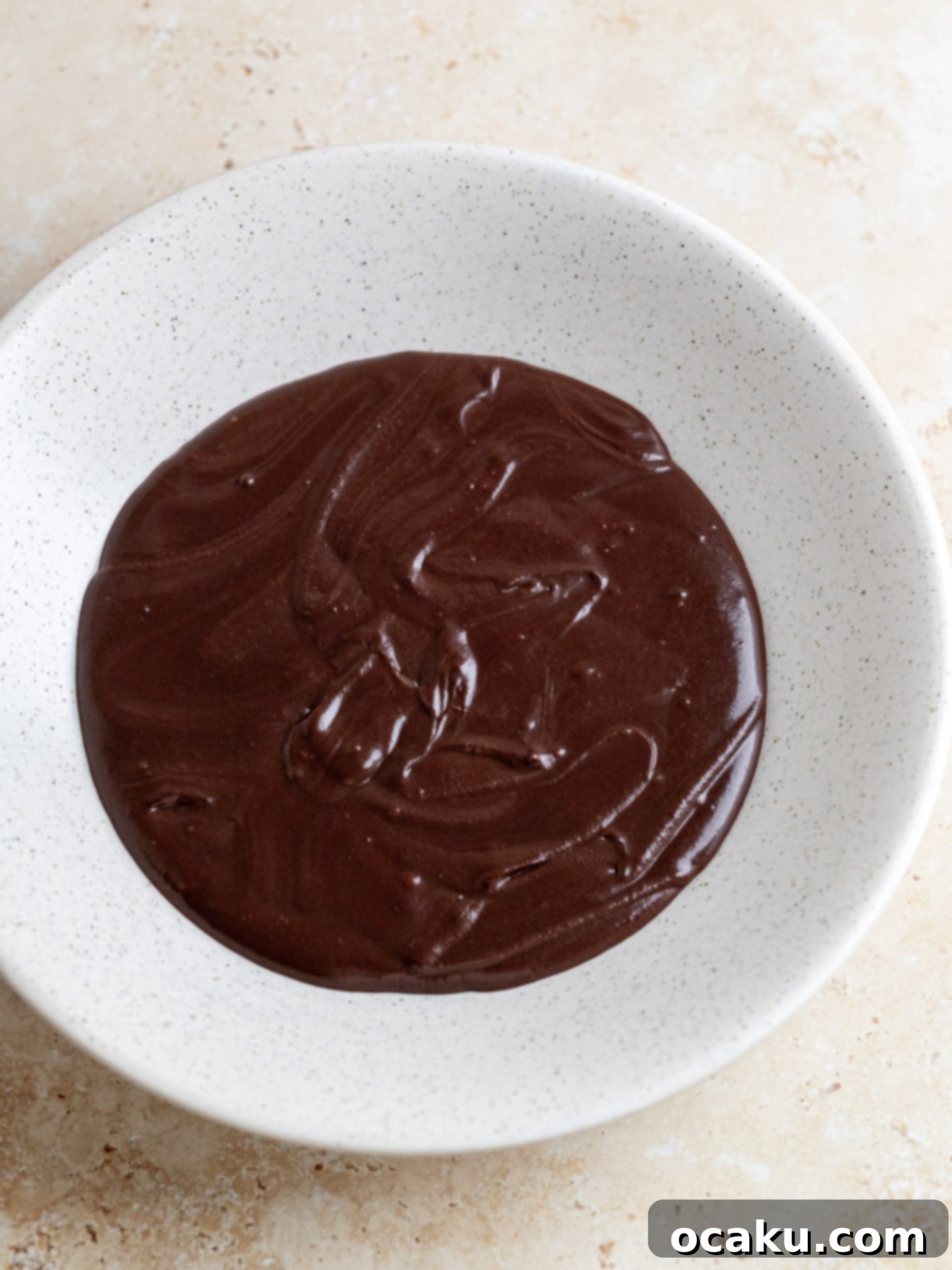 Melting semi-sweet chocolate with hot milk mixture for the fudge sauce.